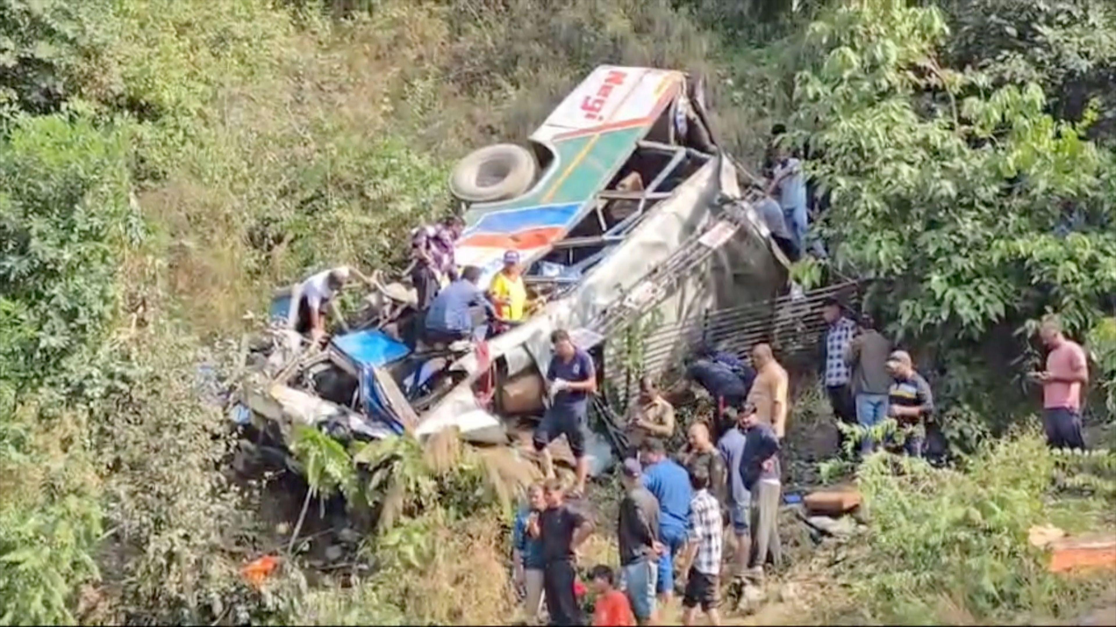 Locals and SDRF officials rescue survivors after a bus falls into a gorge in India's Uttarakhand state. 