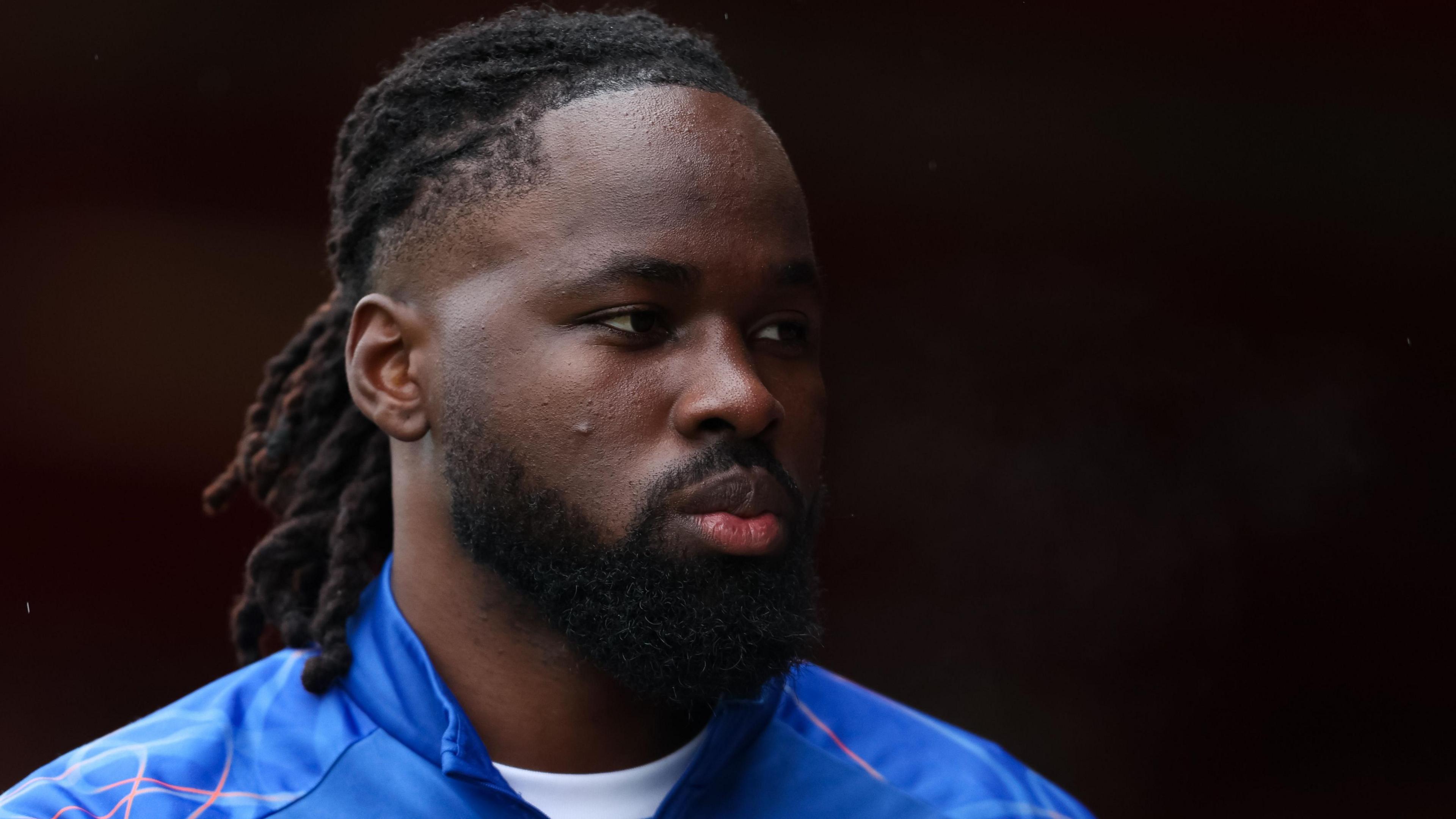 Dynel Simeu looks on before Oldham's League Two fixture at Accrington