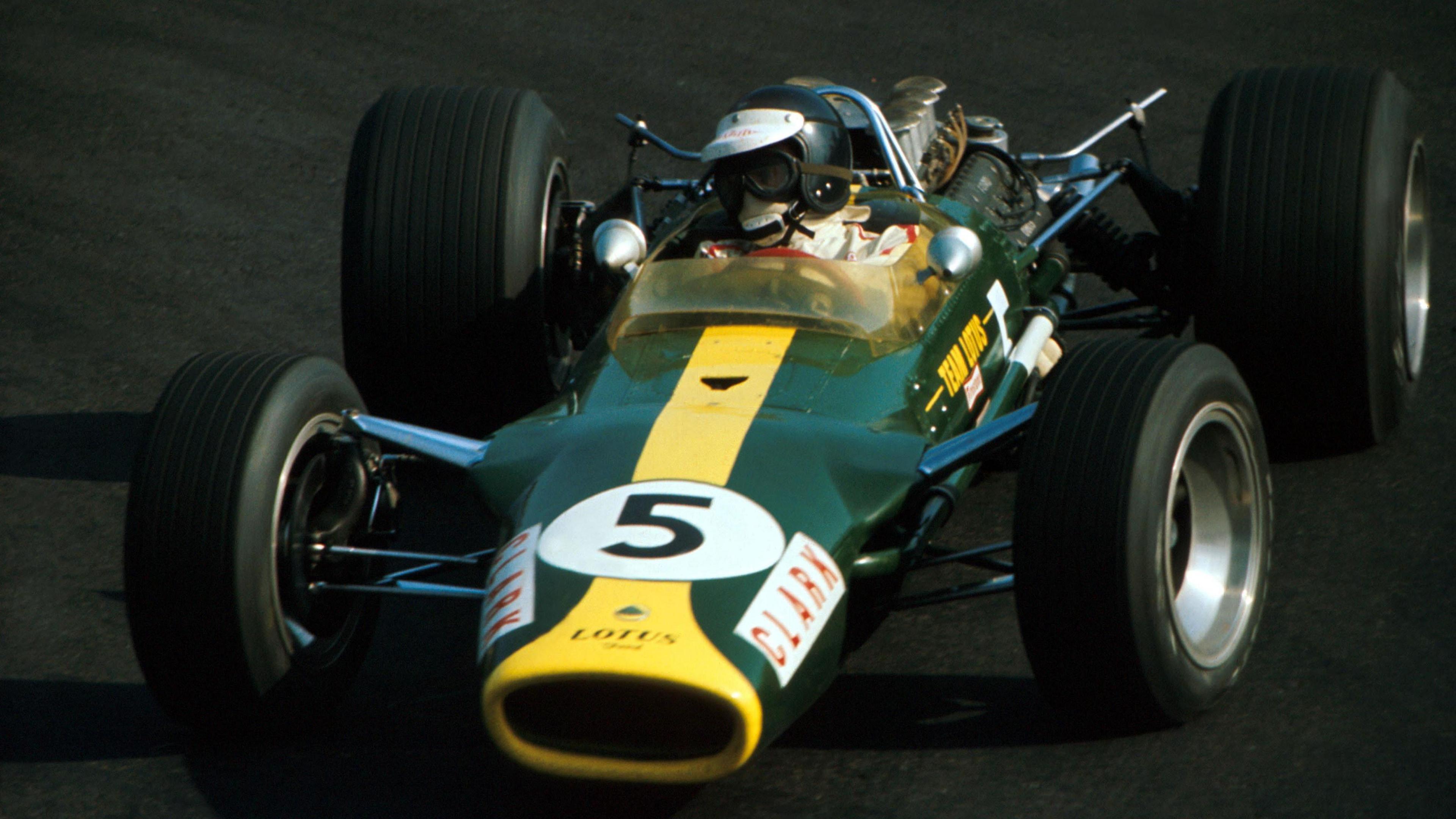 Jim Clark driving the Lotus 49 in the 1967 Mexican Grand Prix. It is in British racing green with a yellow stripe running along the front