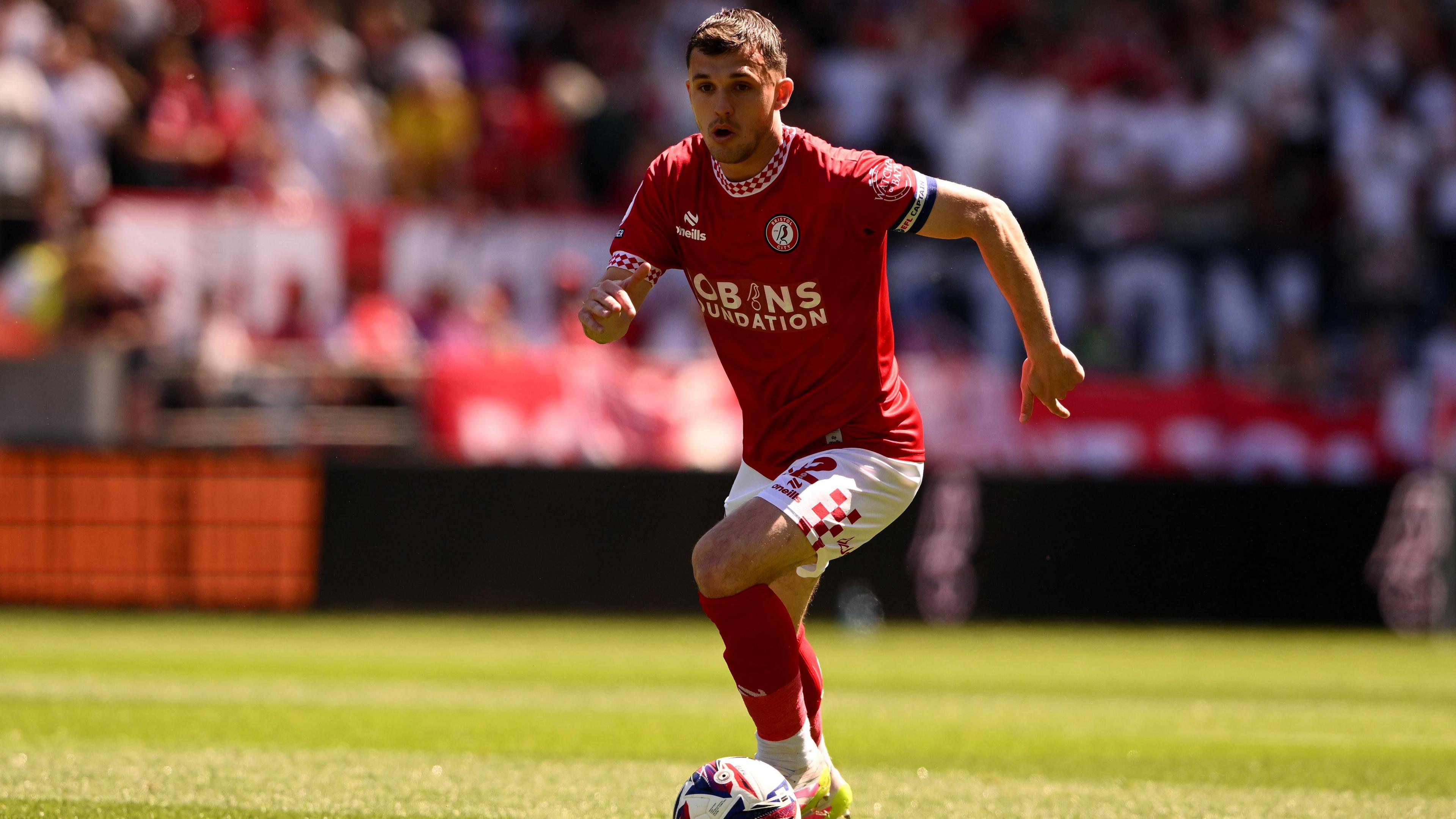 Bristol City captain Jason Knight brings the ball forward.