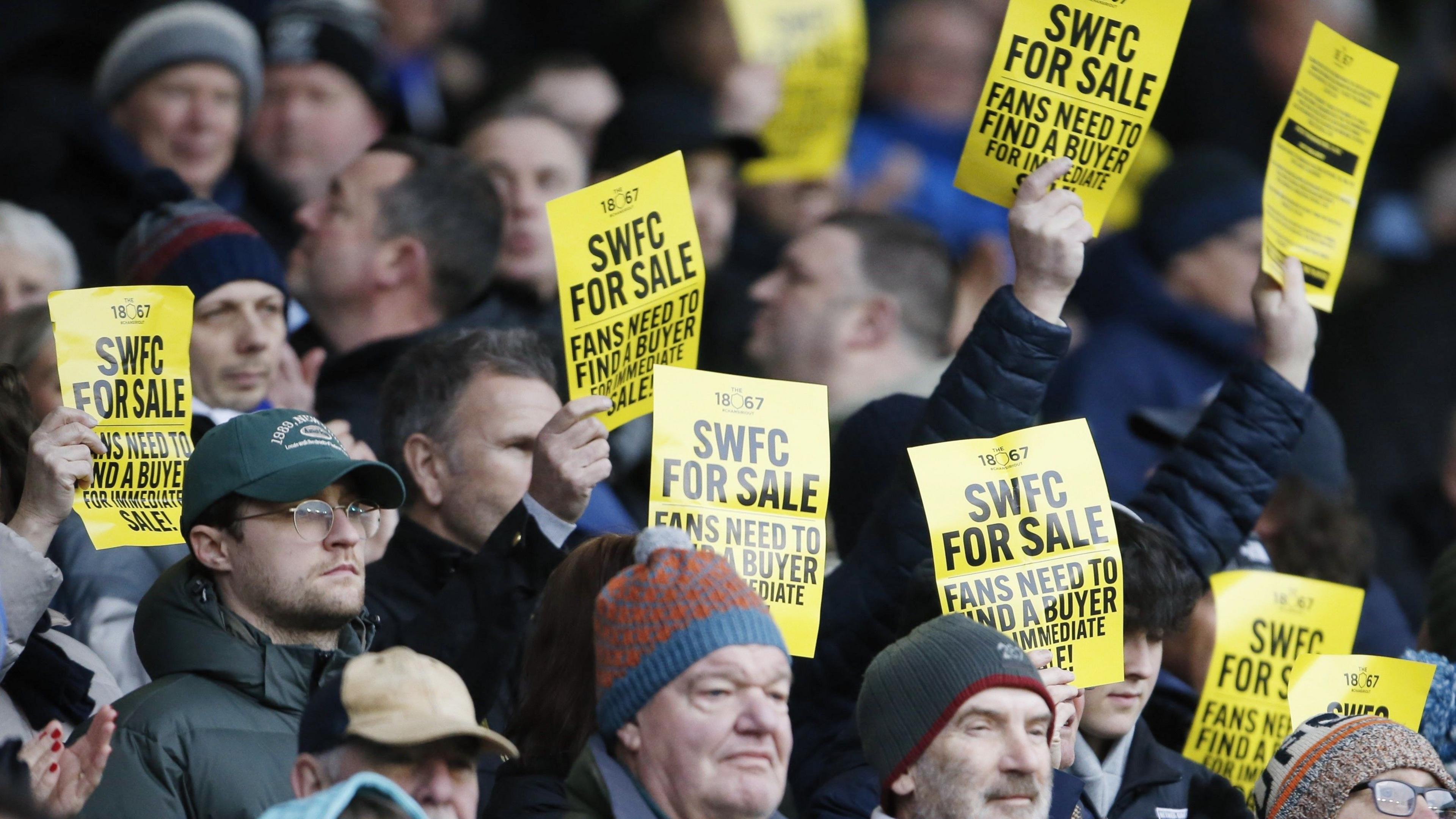Owls fans hold SWFC for sale banners