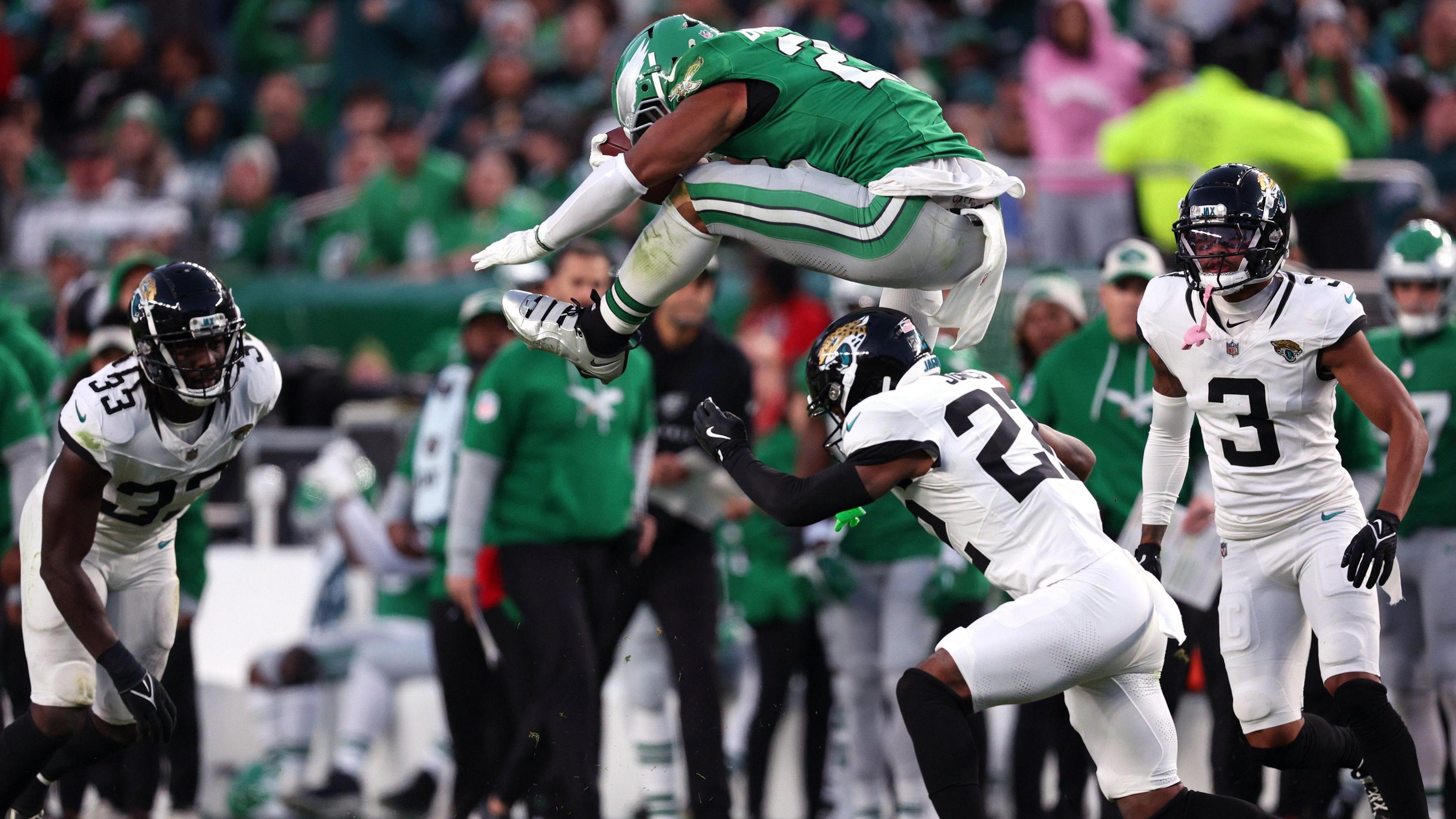 Saquon Barkley of the Philadelphia Eagles leaps over a Jacksonville Jaguars defender during their game in the NFL