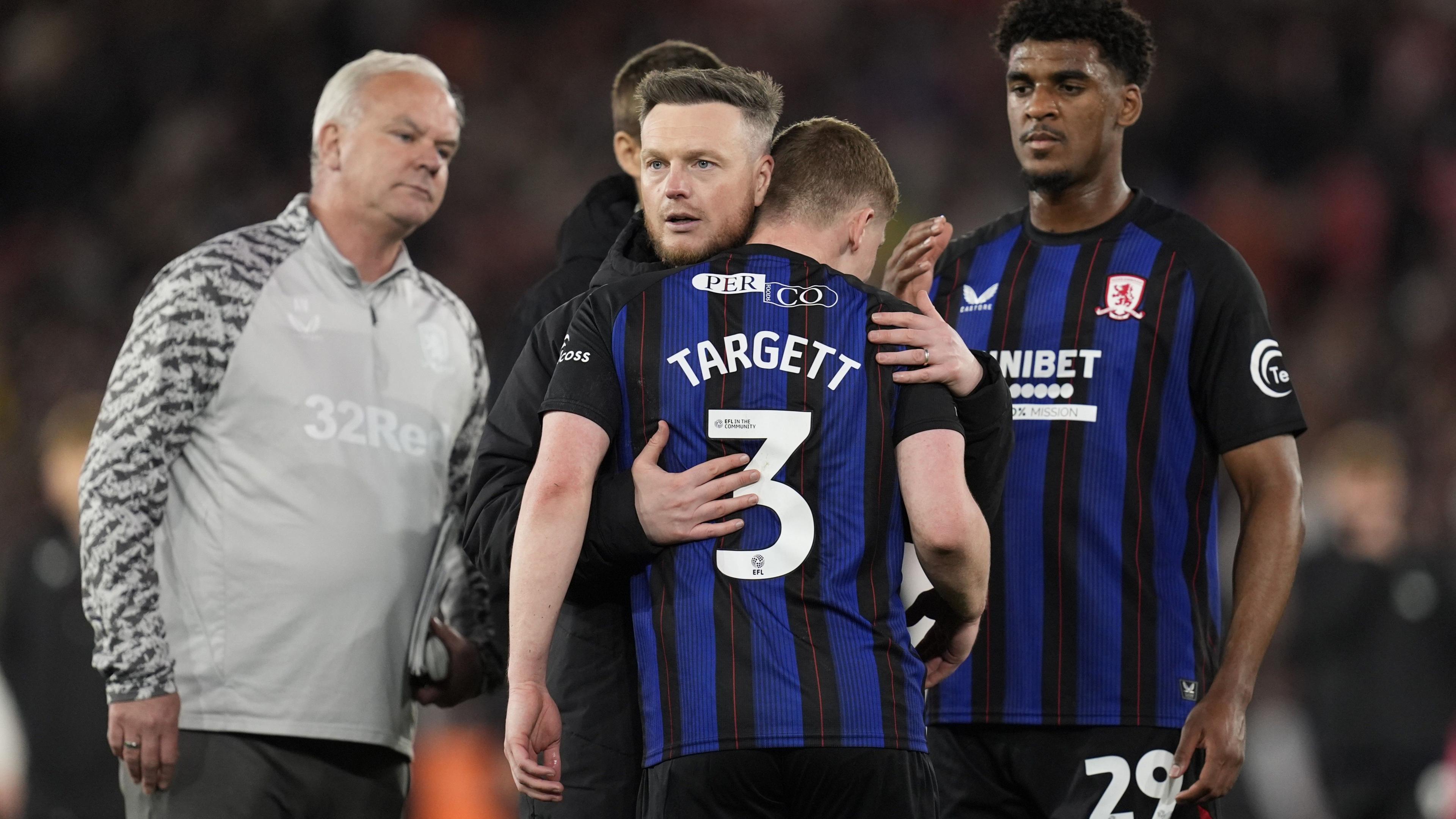 Middlesbrough boss Kim Hellberg consoles one of his players
