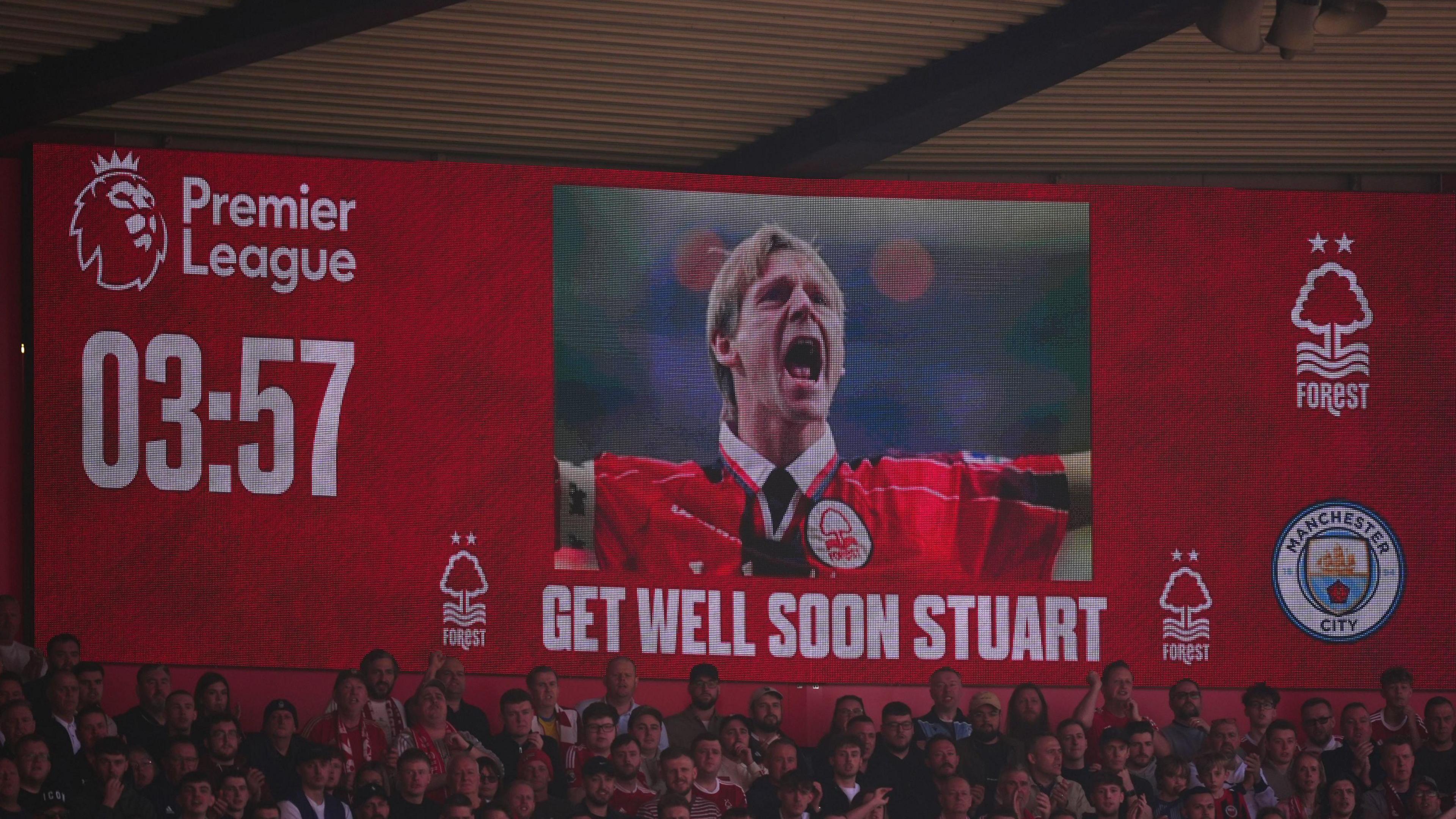 "Get well soon Stuart" displayed on big screen