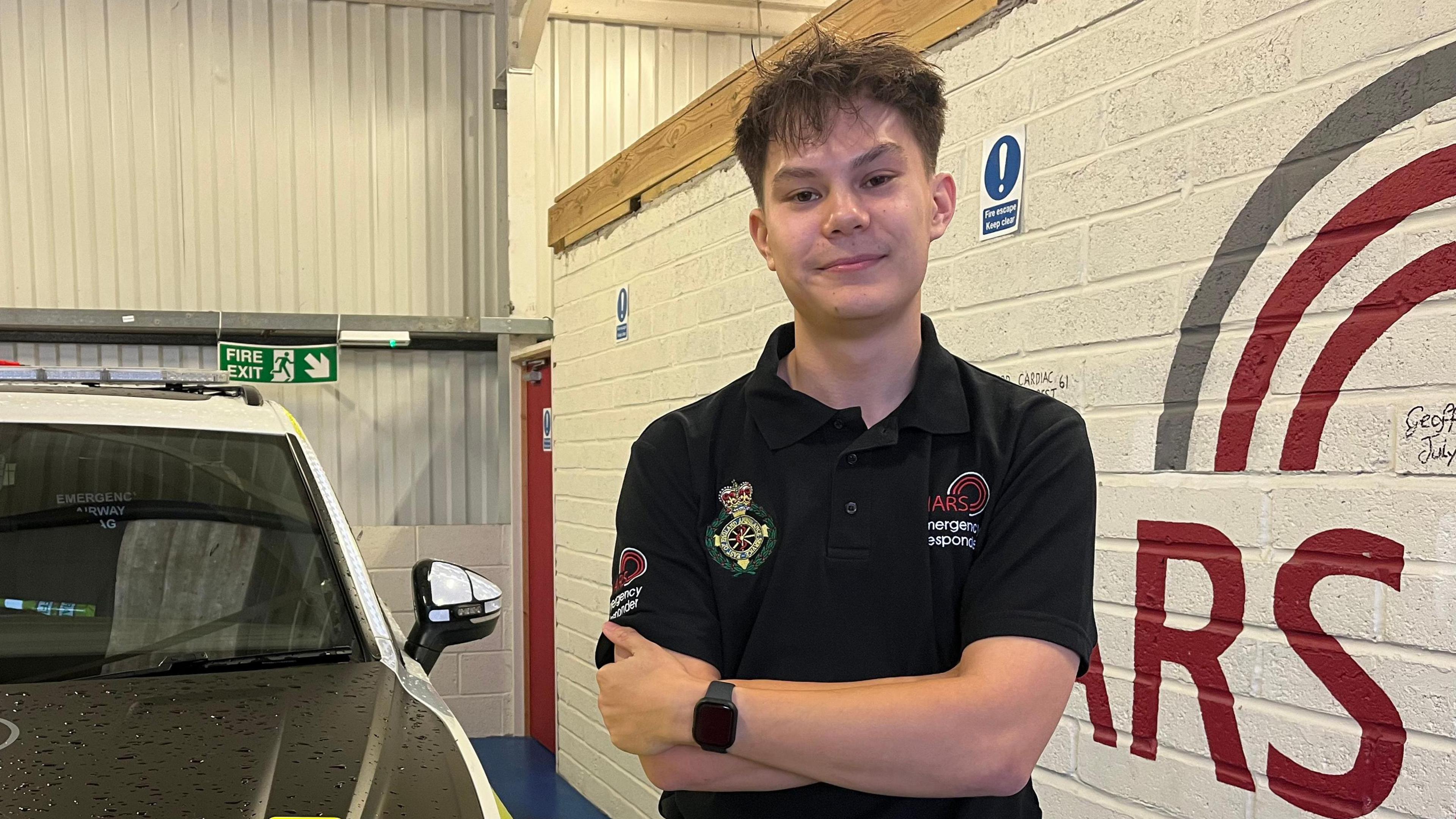 Medical student Konran Le has dark brown hair and wears a black branded Nars T-shirt.