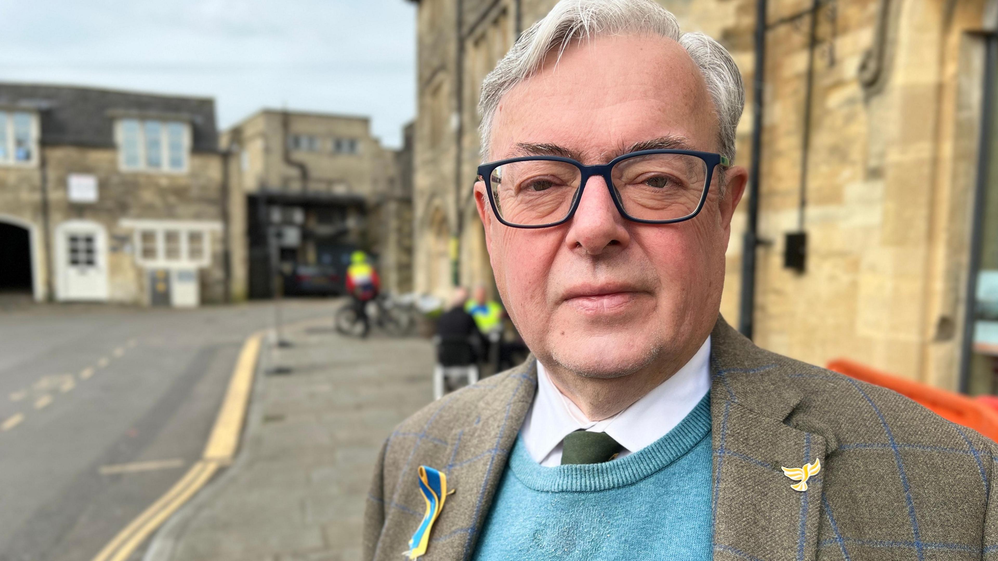 Gavin Grant from Wiltshire Council stands in the street wearing a suit