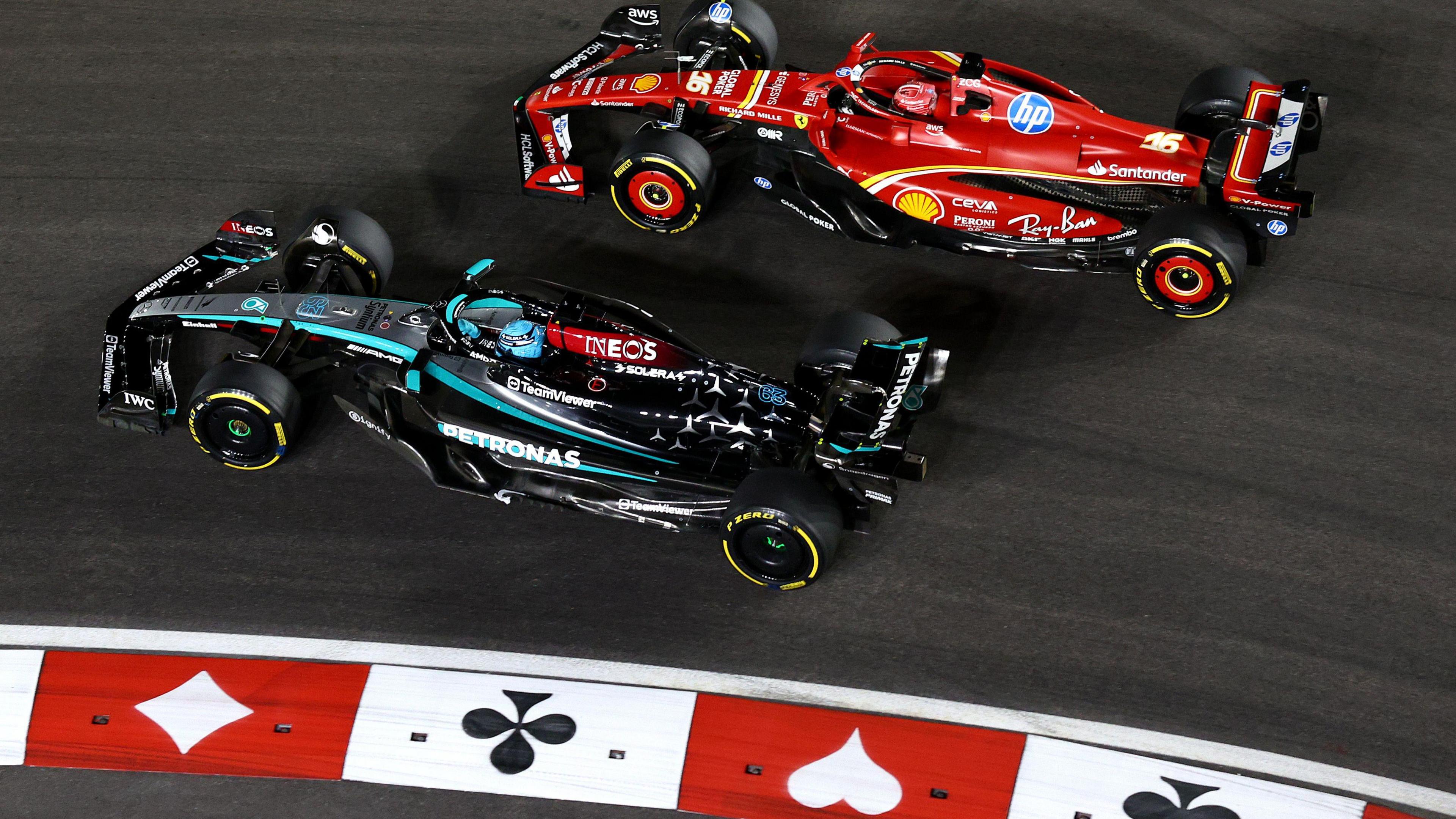 George Russell runs side-by-side with Charles Leclerc on the outside of a corner during the early stages of the Las Vegas Grand Prix