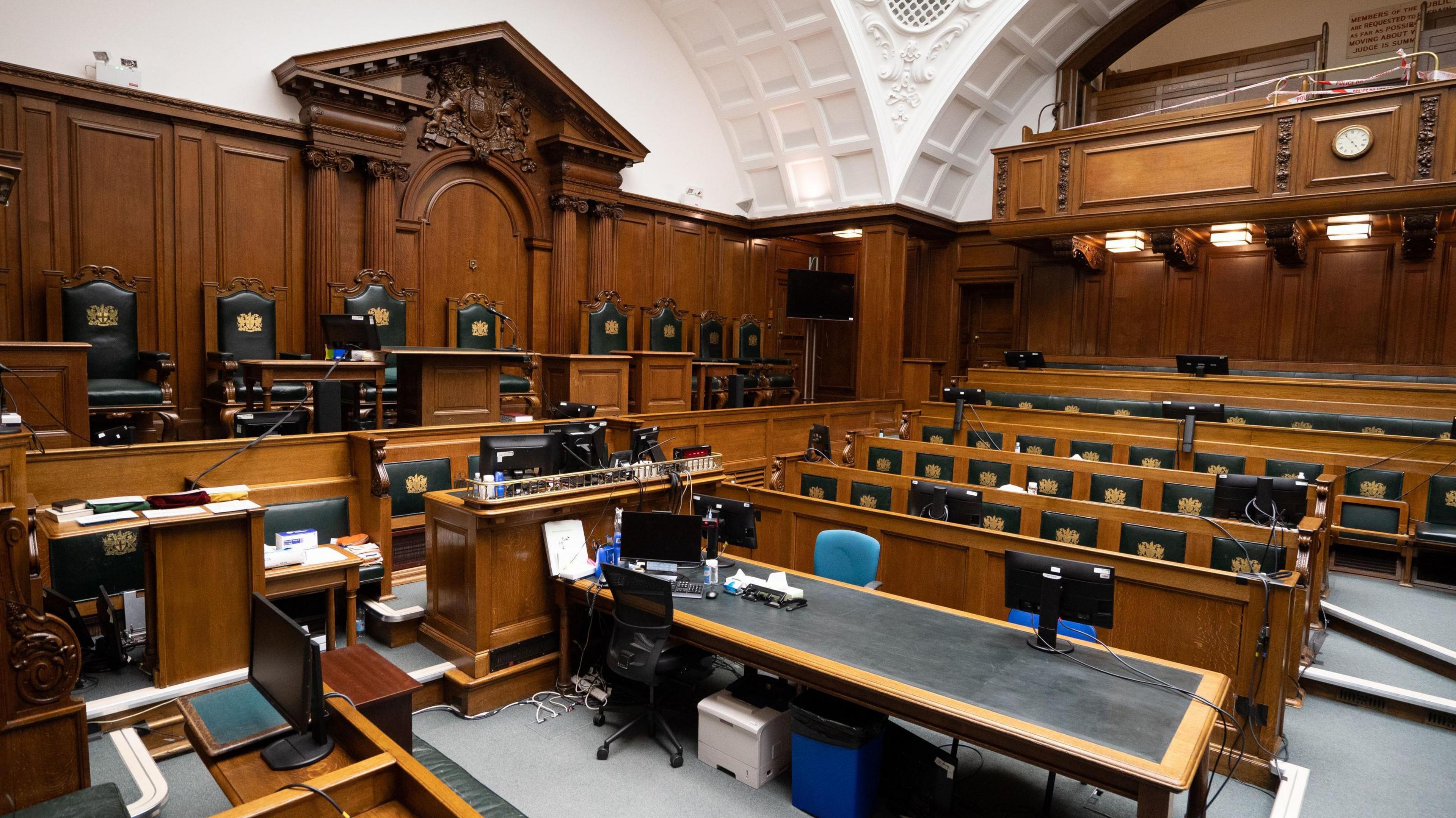 Court No 1 of the Old Bailey, showing the wood panelled benches for the judge, barristers and jury. 