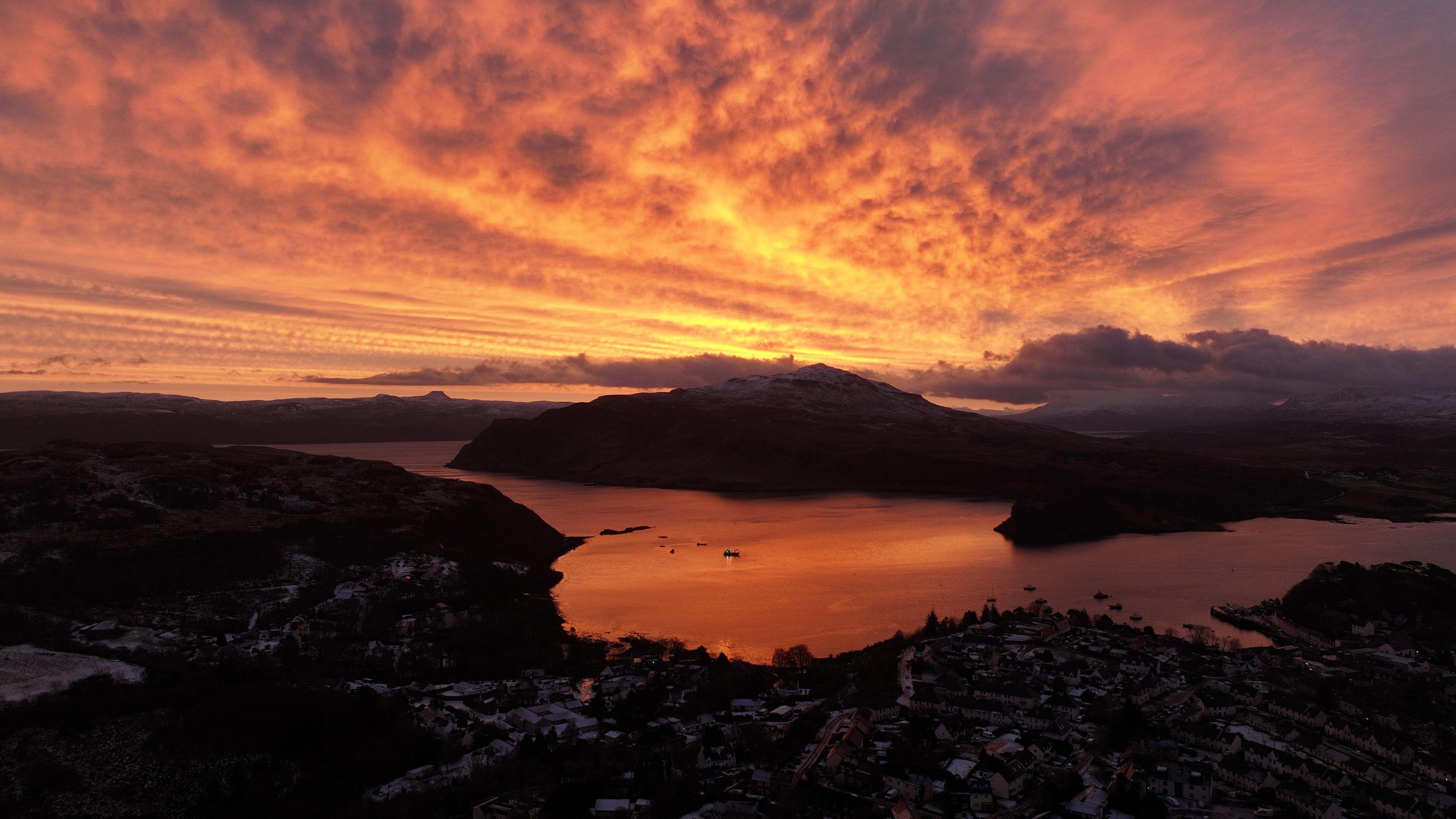 An orange and yellow sky above a town on Skye.