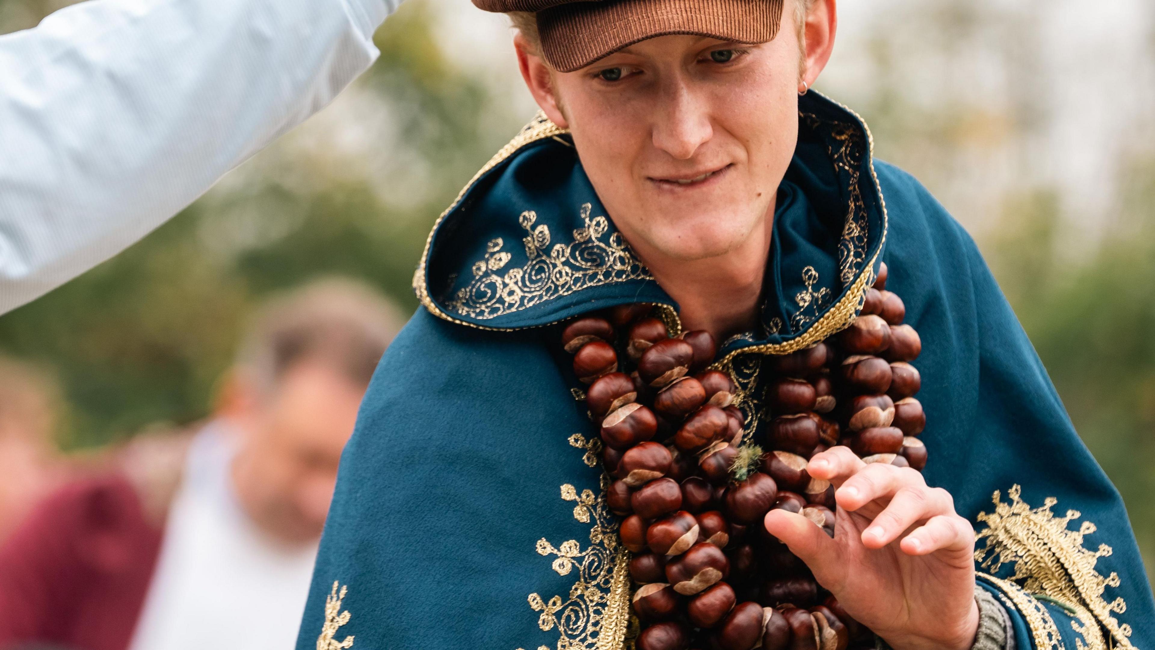 Competitor with multiple strings of conkers around neck.