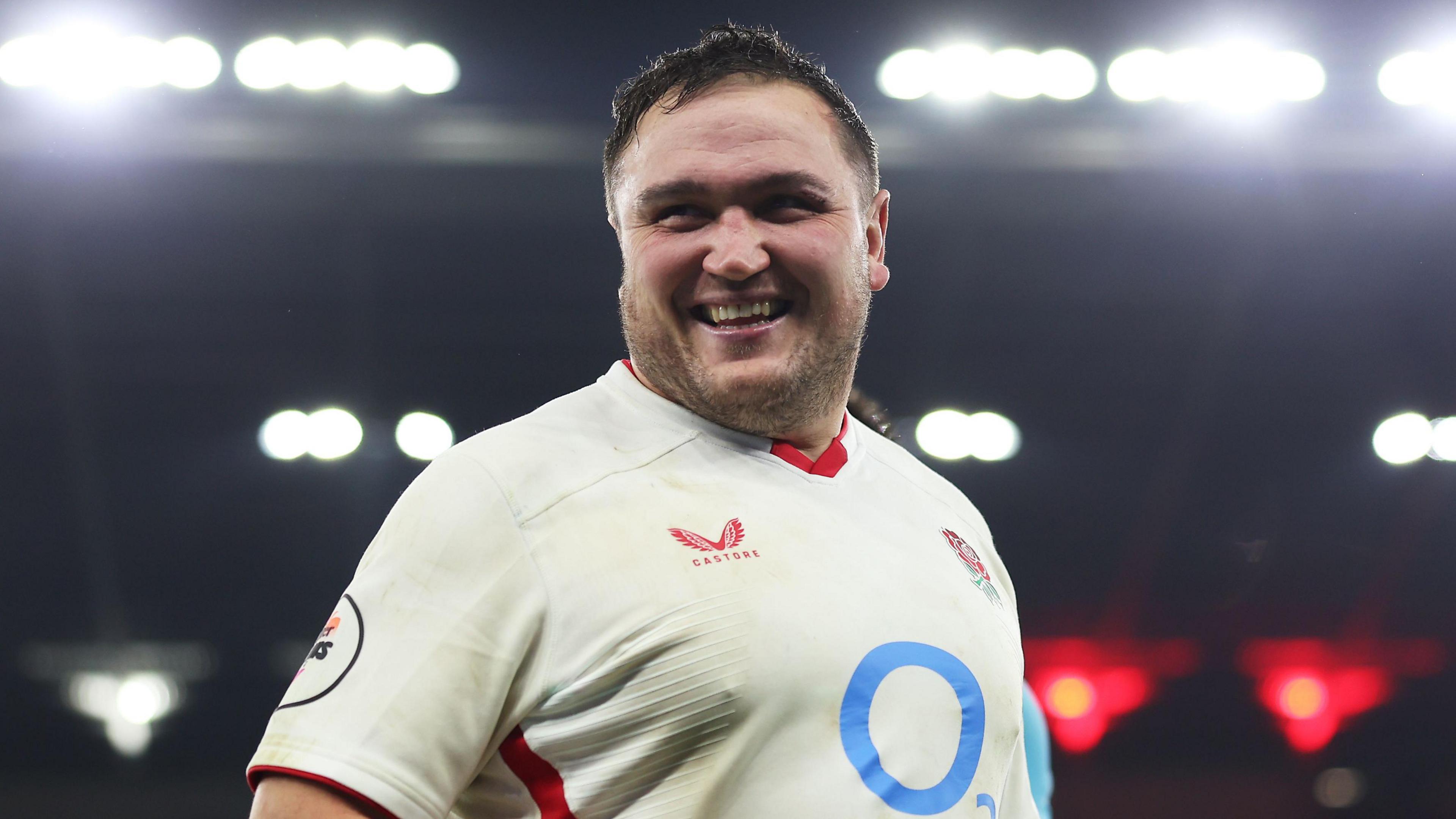 Jamie George smiling while standing on the pitch at the end of England's win against Fiji in November
