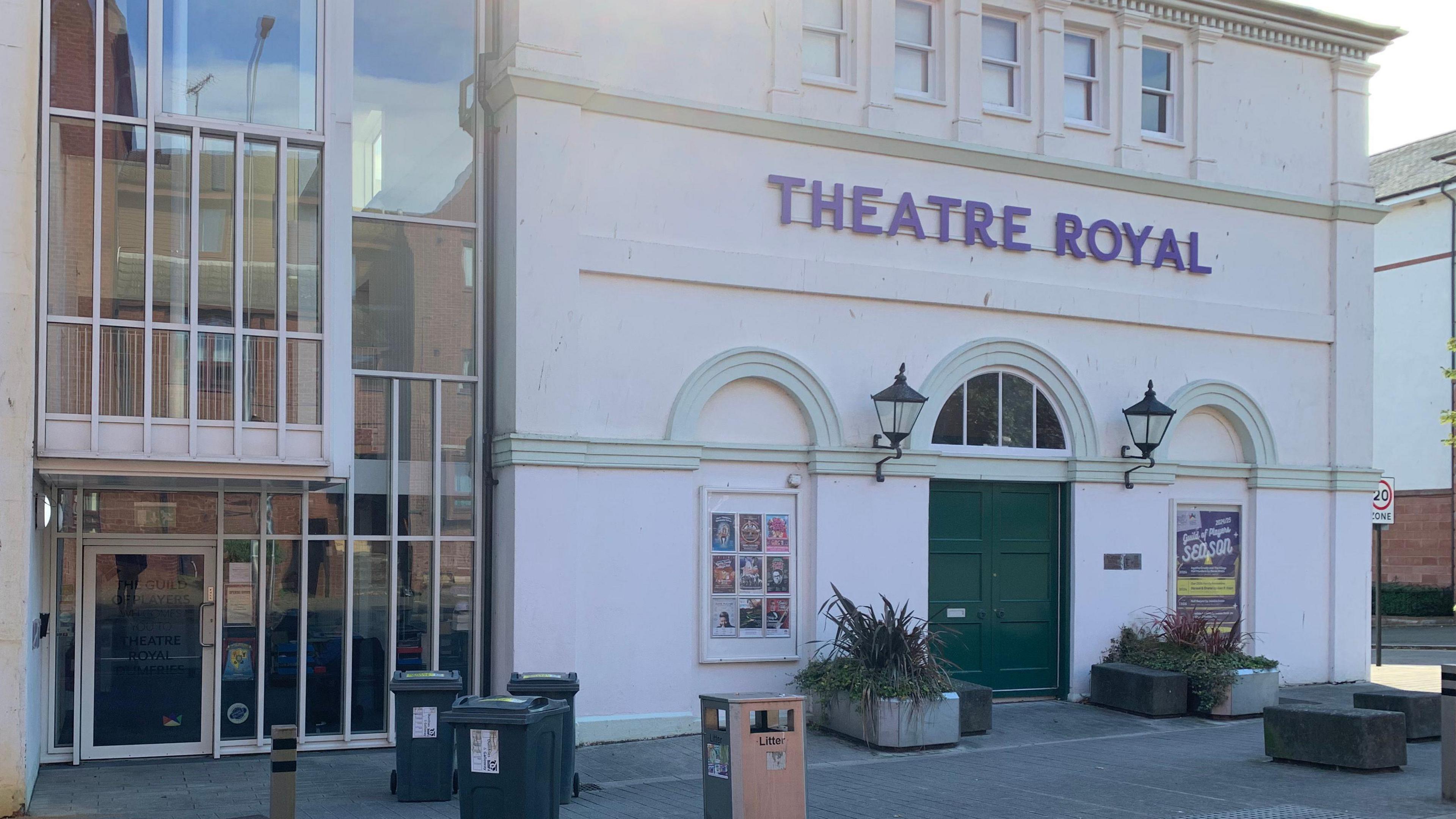 An external view of the Theatre Royal in Dumfries in shade with the sun behind it.