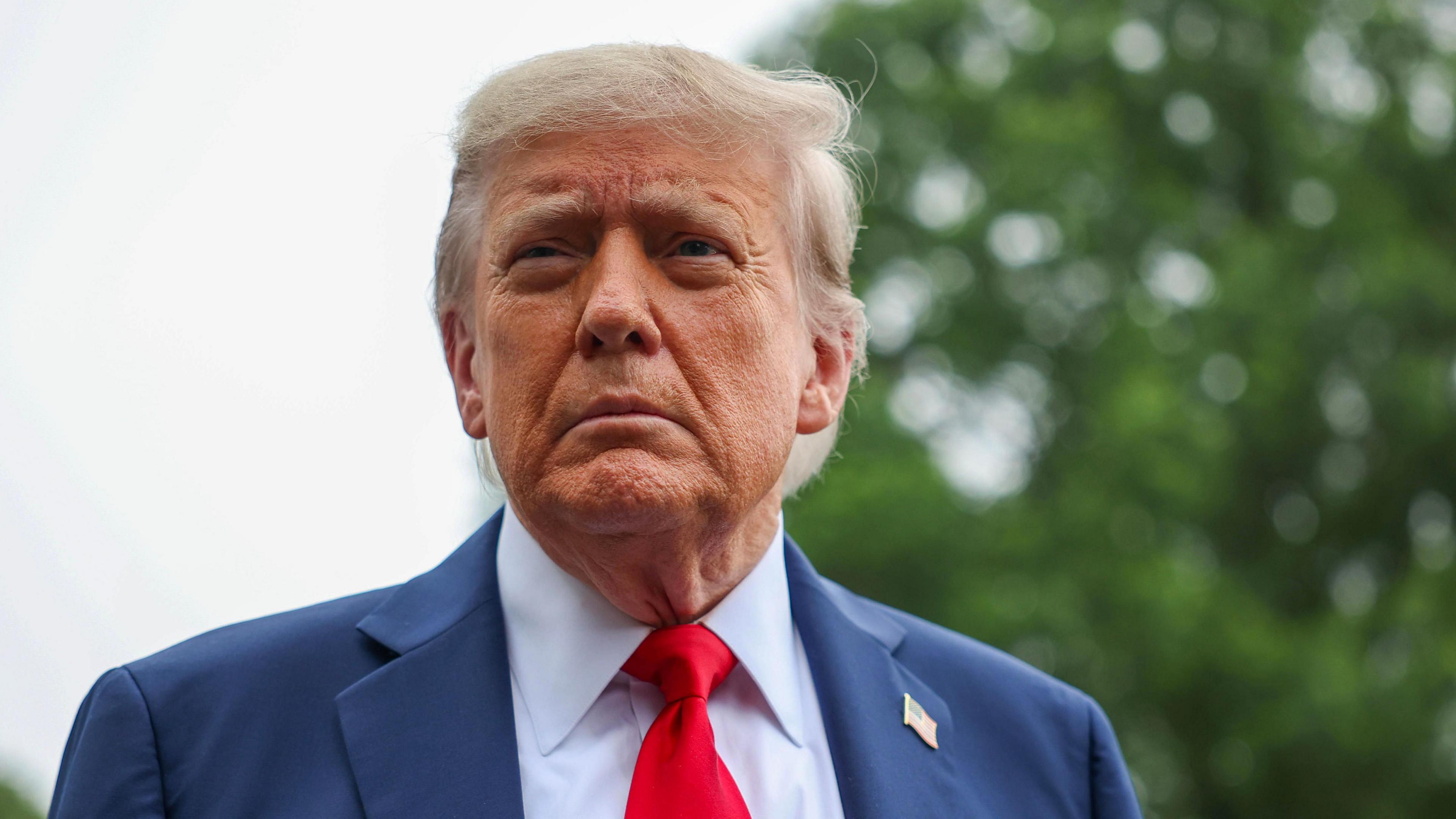 President Trump standing in the grounds of the White House