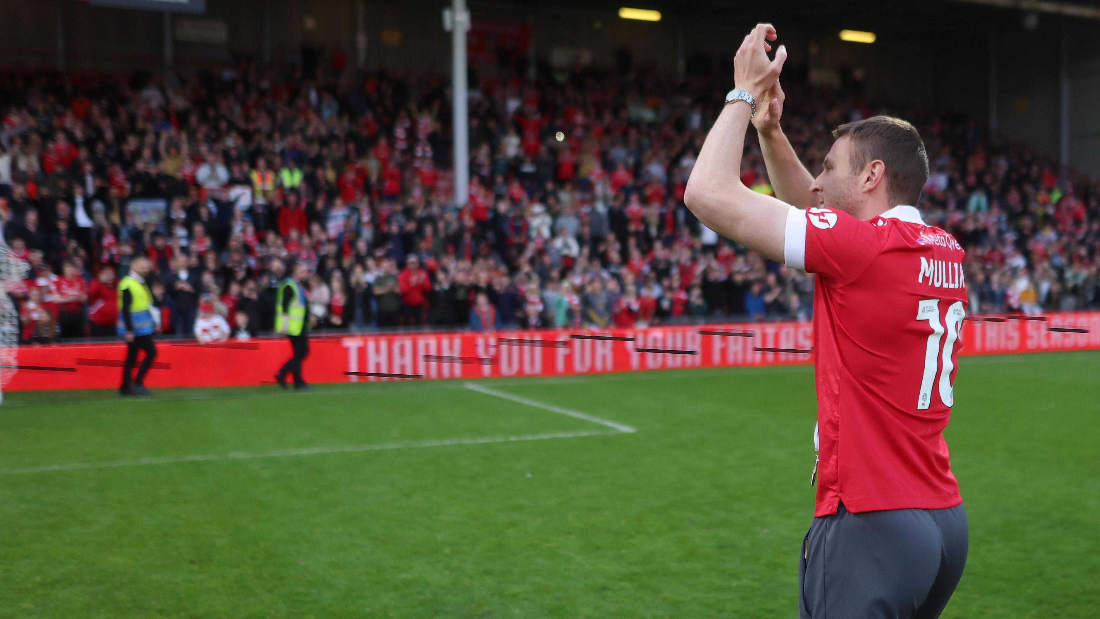 Paul Mullin applauds Wrexham fans at the Stok Cae Ras