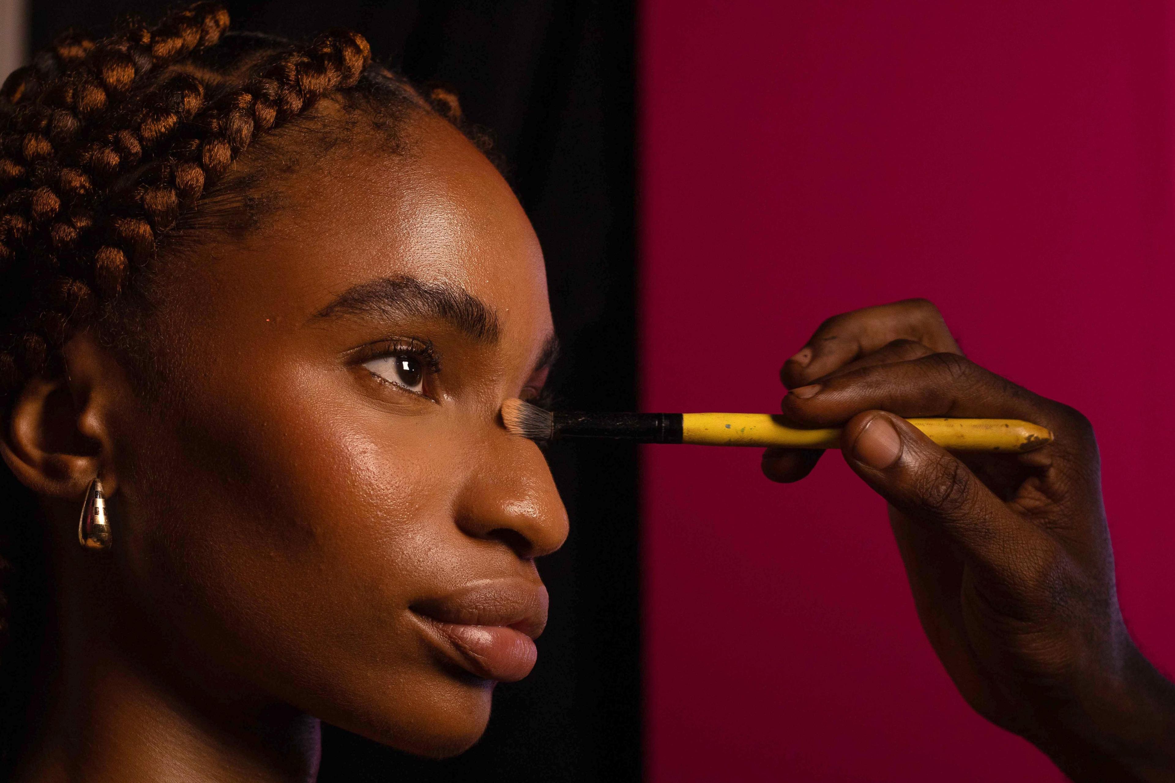 A make-up artist applies powder to a model's face with a brush backstage during the Lagos Fashion Week on 25 October. Lagos Fashion Week runs from 24 to 27 October and showcases designs from Nigerian and African fashion designers.