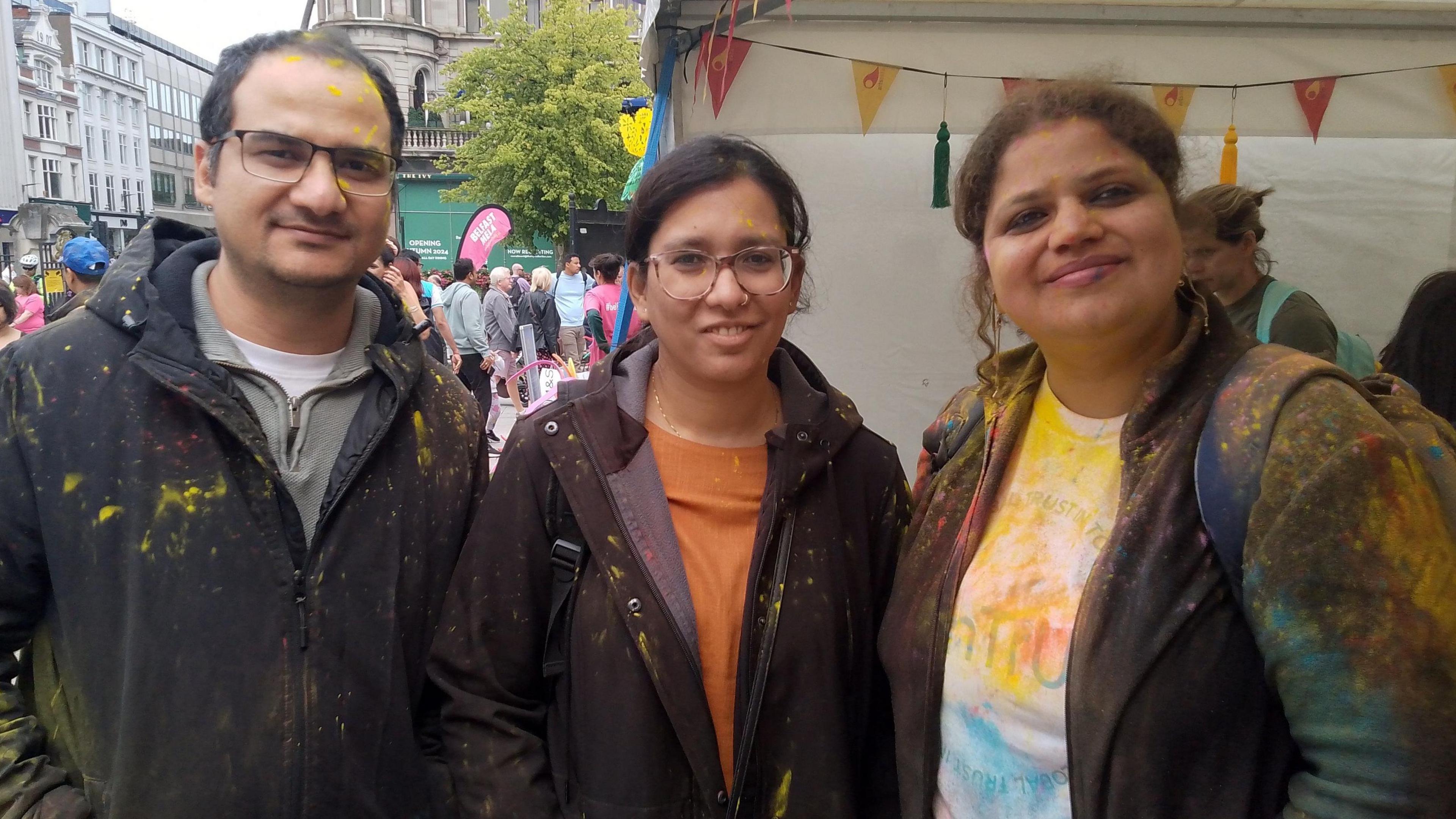 Shivata Bhat and two friends. They are splattered with colour from the festival