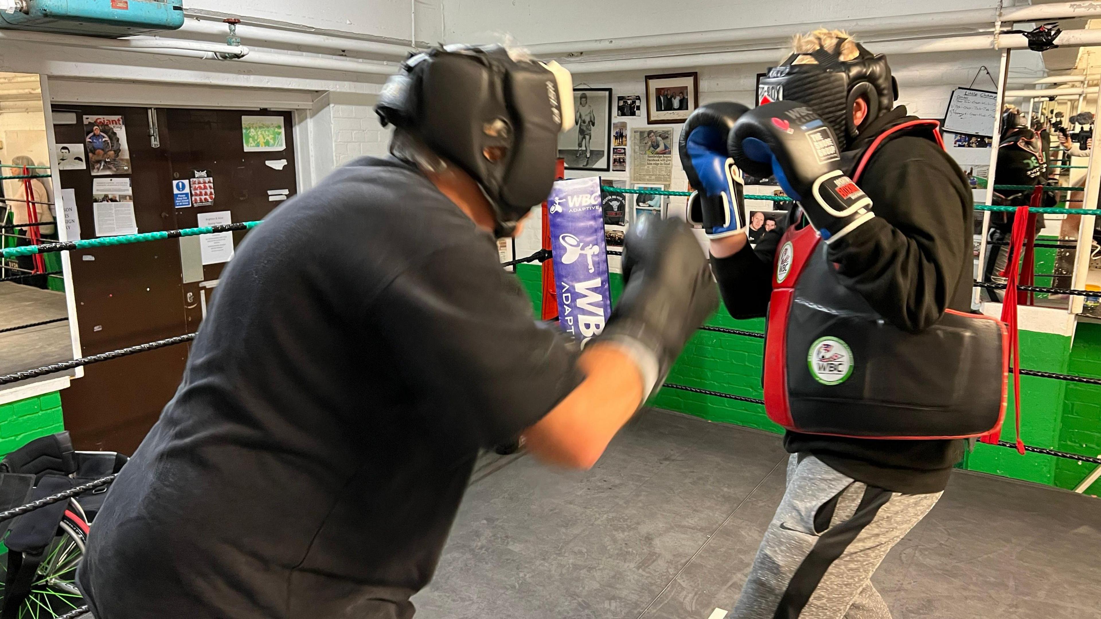 Two people boxing in a boxing ring