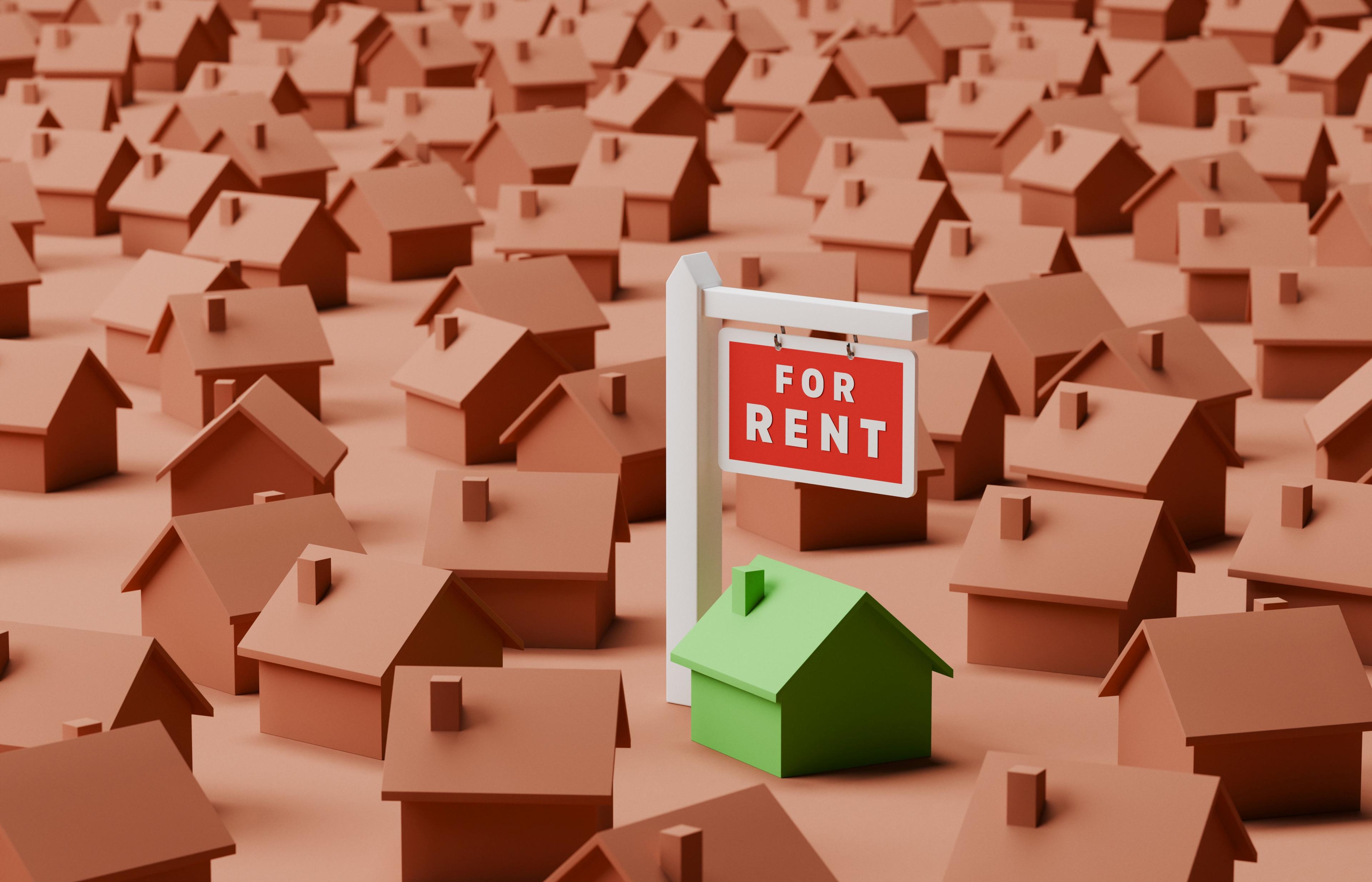 Conceptual image of a single green house amongst many brown ones with a for rent sign. Rental market concept. There one for rent sign next to the green house.