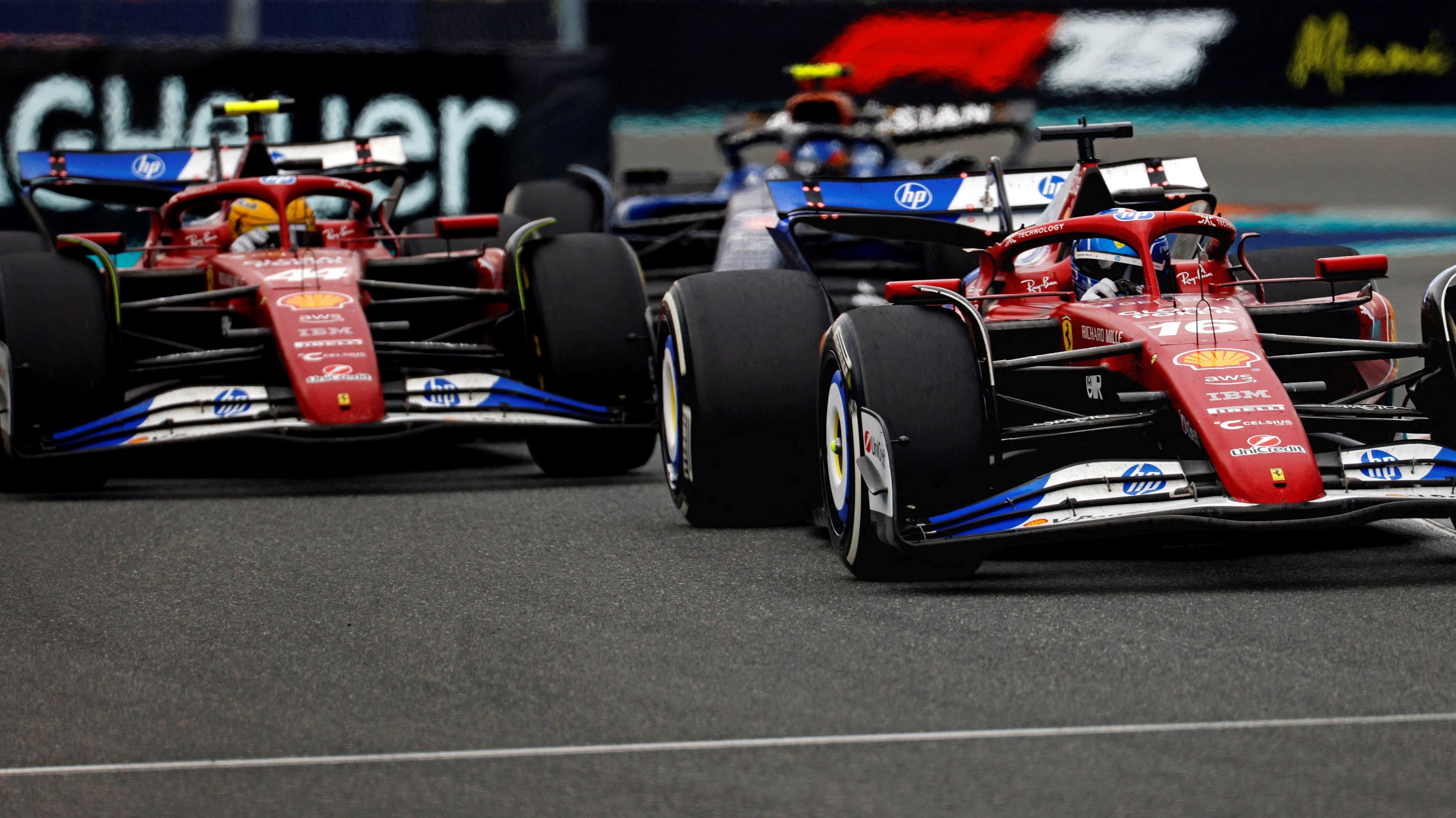 The Ferraris of Lewis Hamilton and Charles Leclerc racing at the Miami Grand Prix