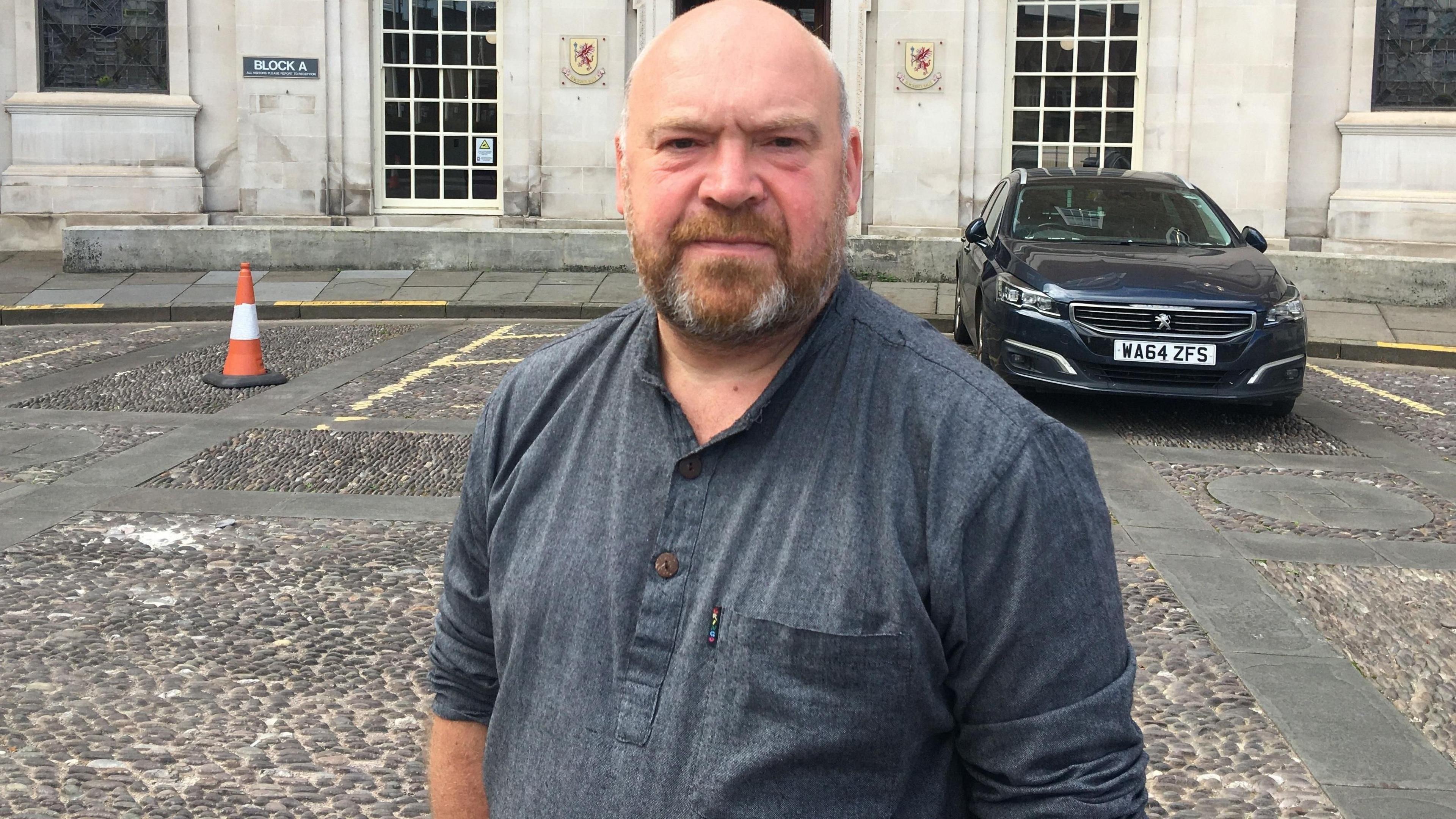 Man in front of building and cobbled streets