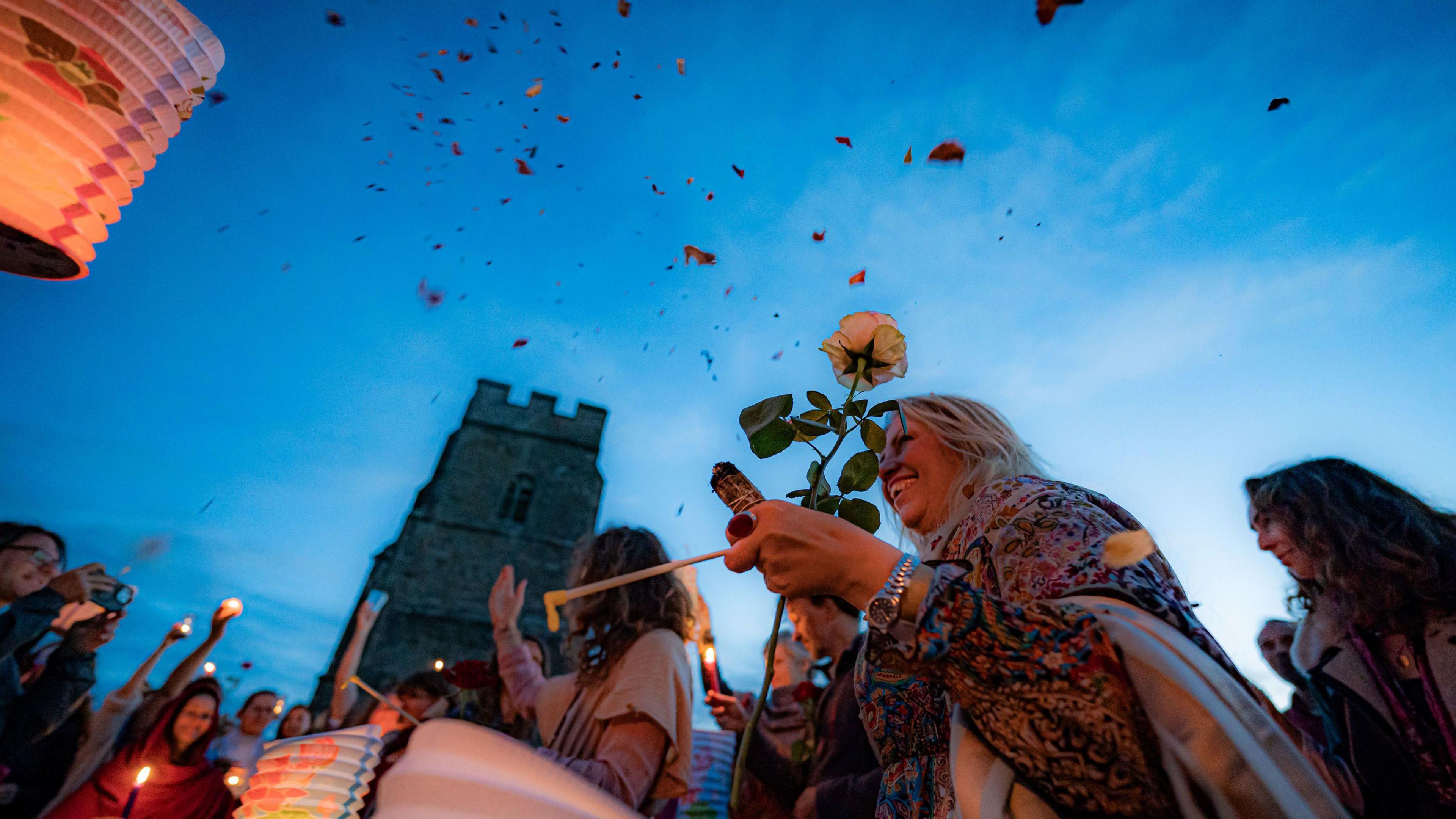 Rose petals in the air and people cheering