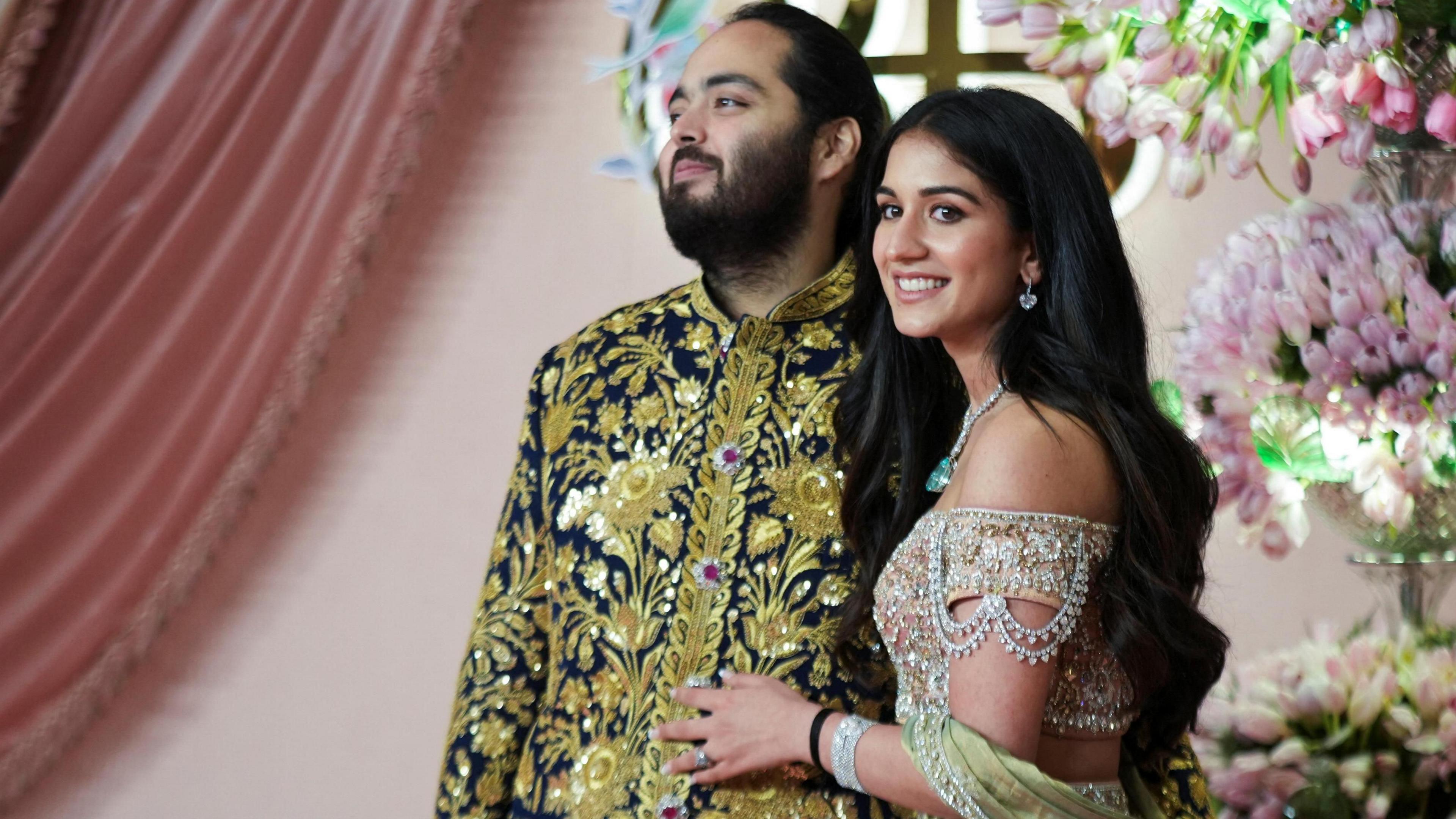 Anant Ambani, son of businessman Mukesh Ambani, poses with his fiance Radhika Merchant on the red carpet during the sangeet ceremony at Jio World Centre, Mumbai, India, July 5, 2024.