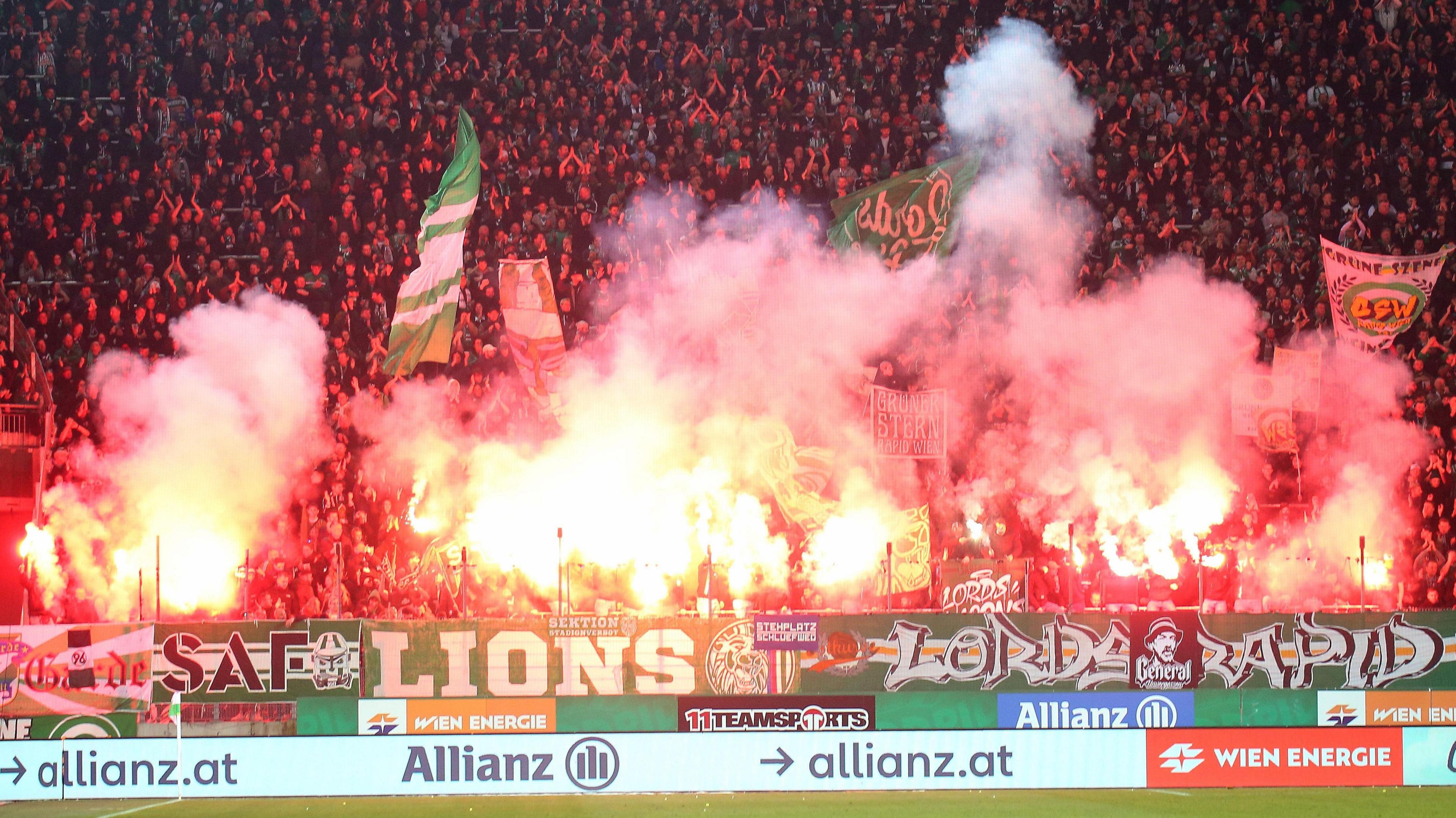 Rapid Vienna fans light flares at a derby against Austria Vienna