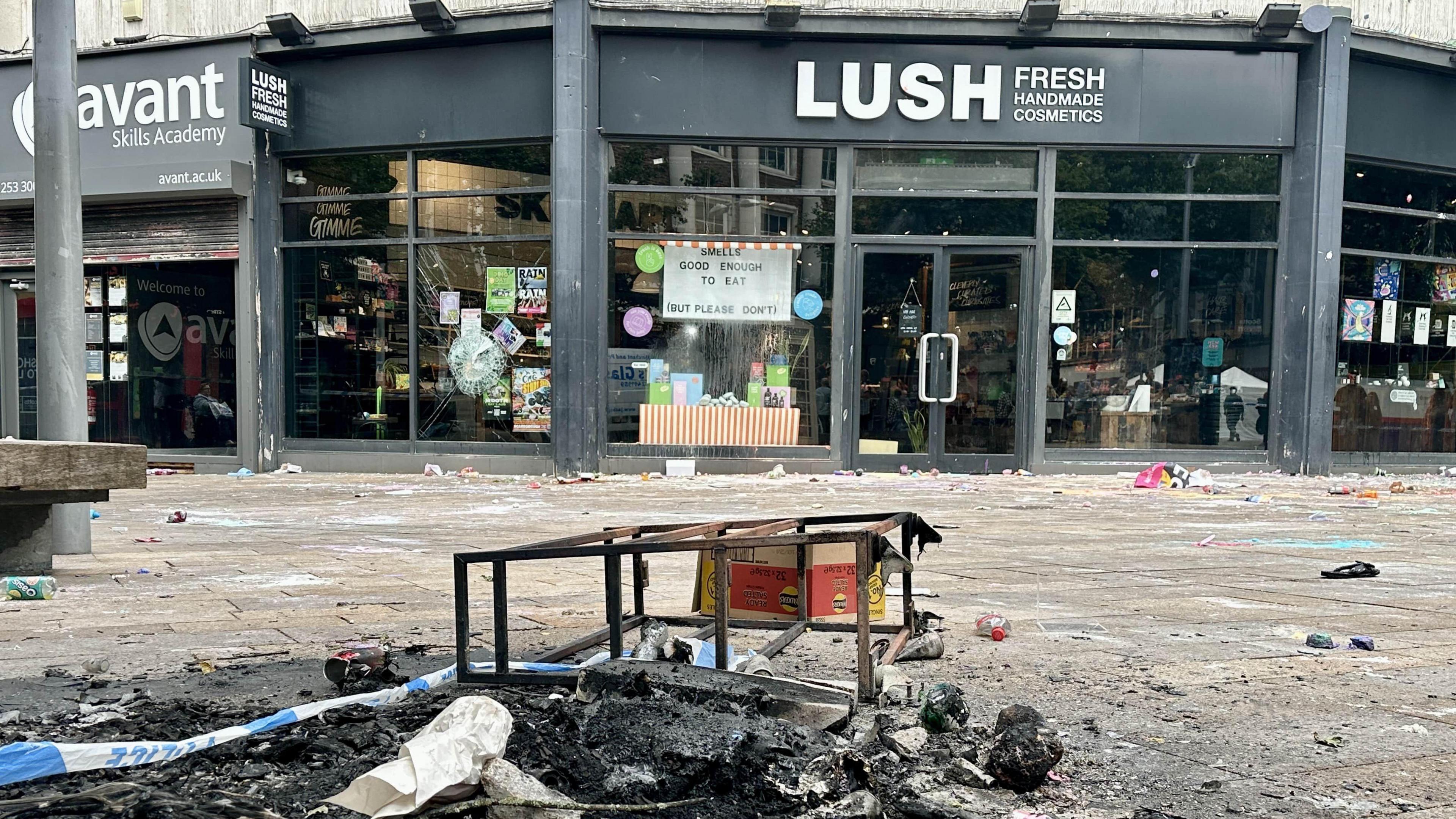 The Lush shop in Hull city centre, with burnt wreckage and police tape outside. 