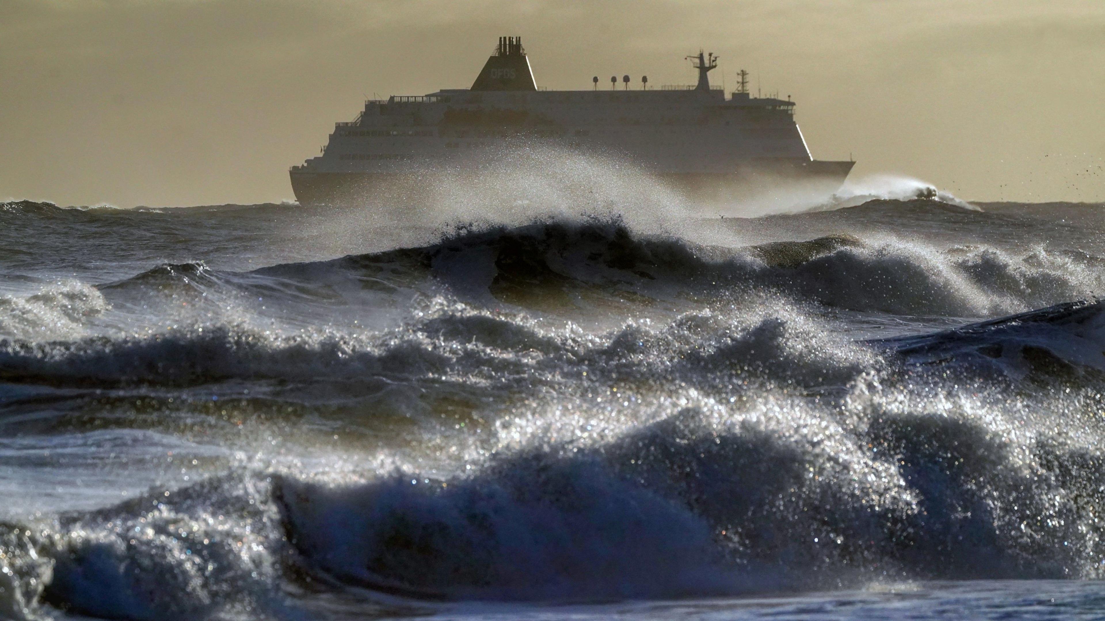 The DFDS King Seaway enters the Mouth of the Tyne on the north east coast in rough seas under a grey sky