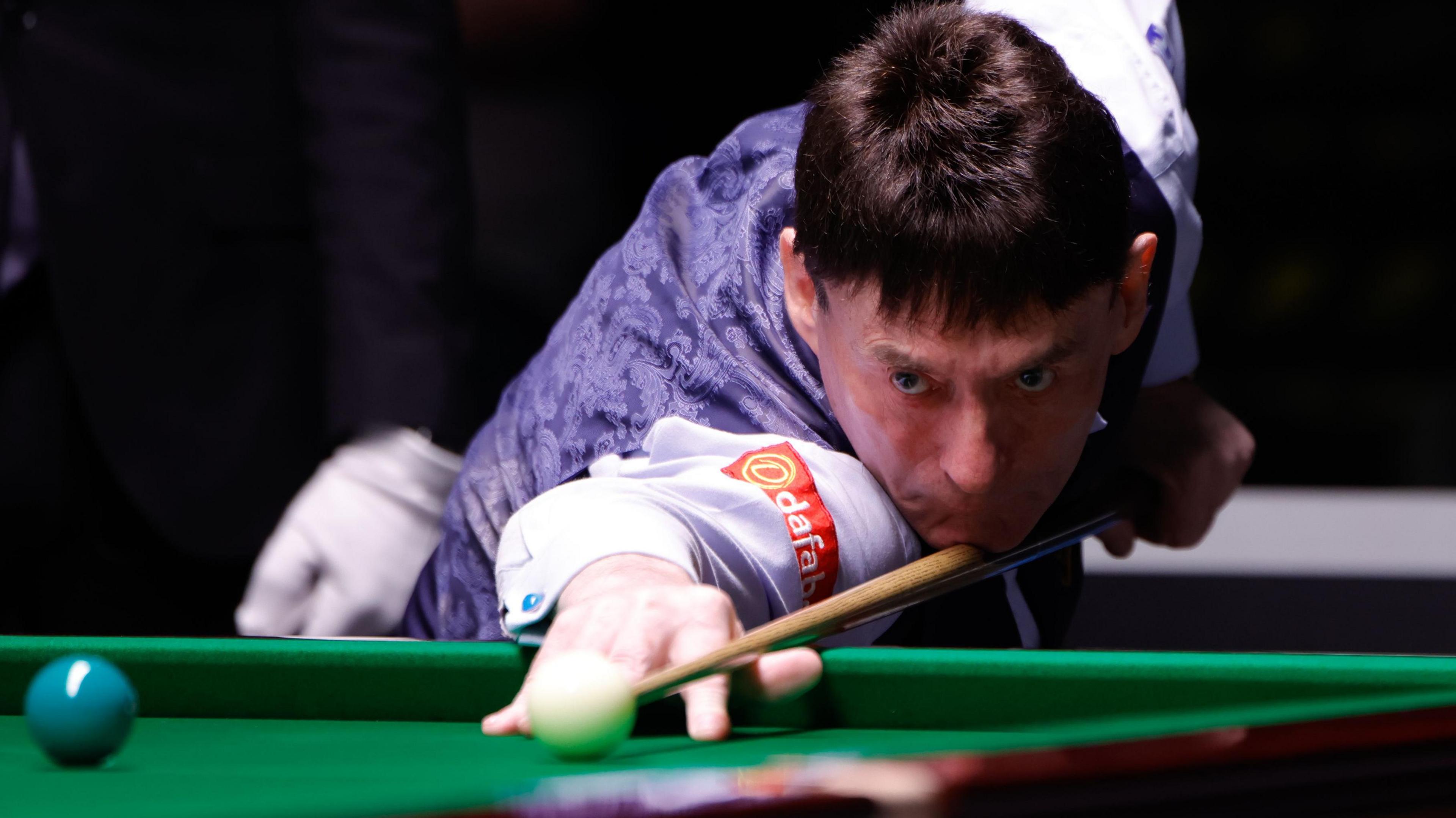 Jimmy White plays a shot