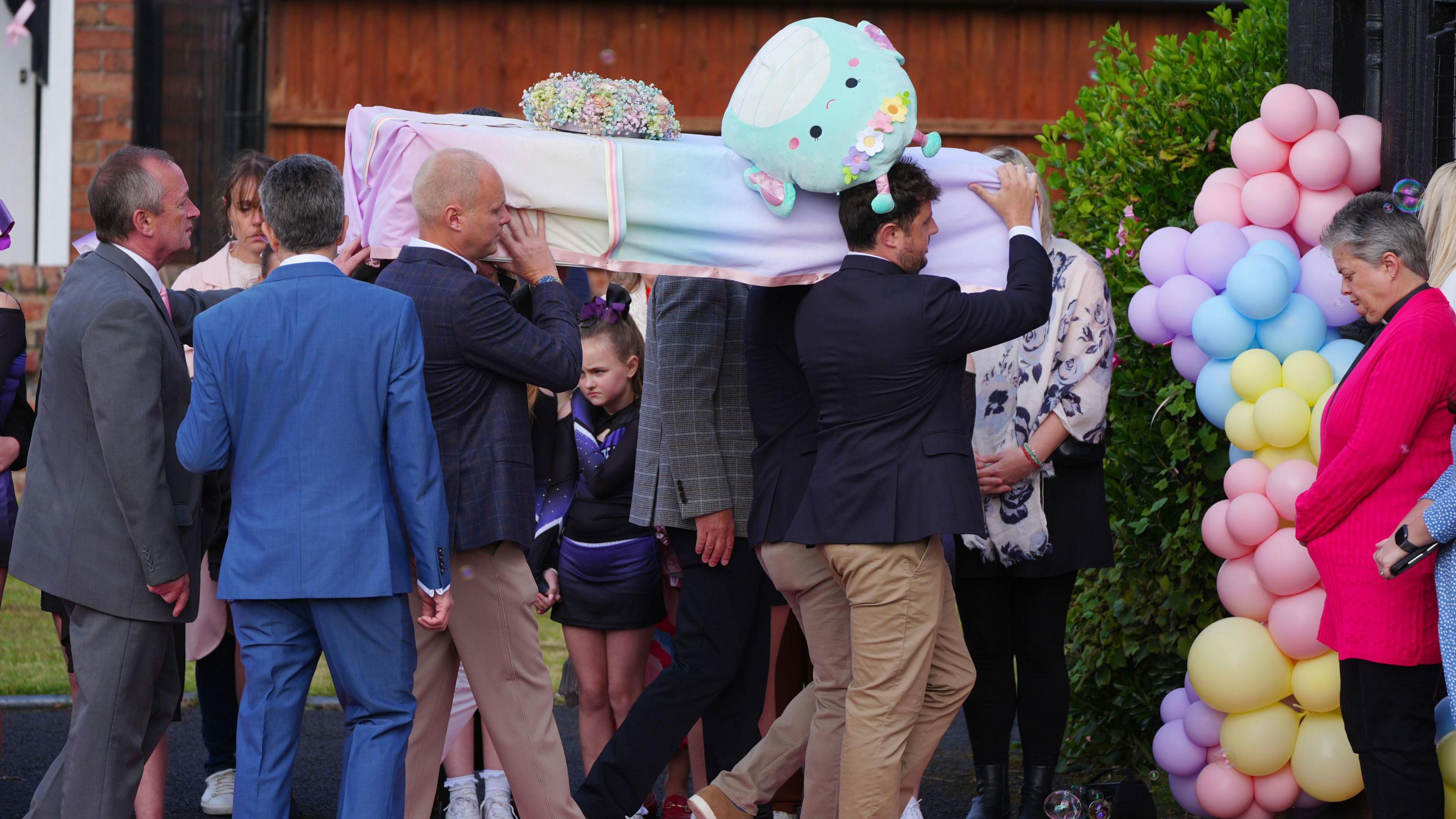 The coffin of Elsie Dot Stancombe is carried into St John's Church in Birkdale