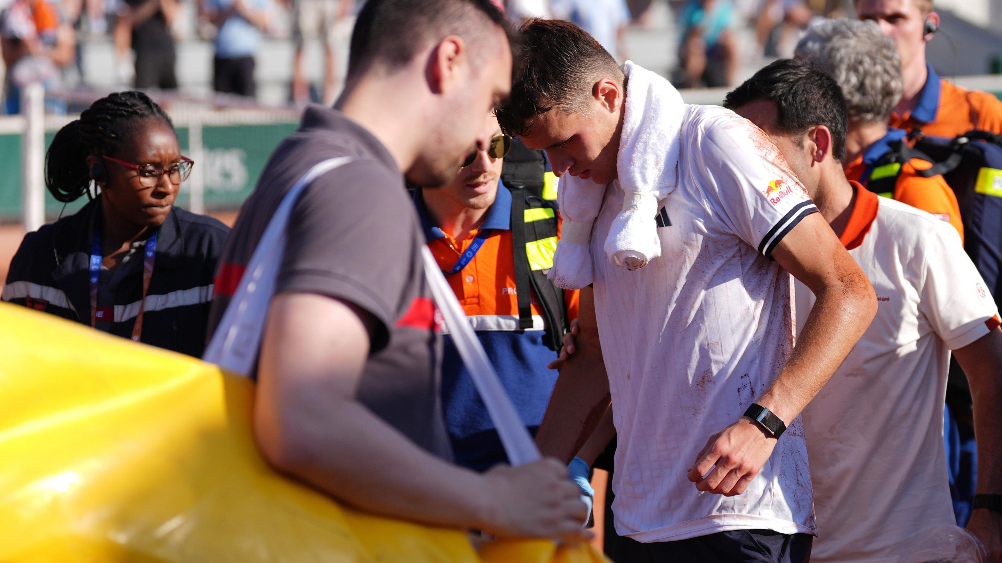 Jakub Mensik receives medical attention after his match