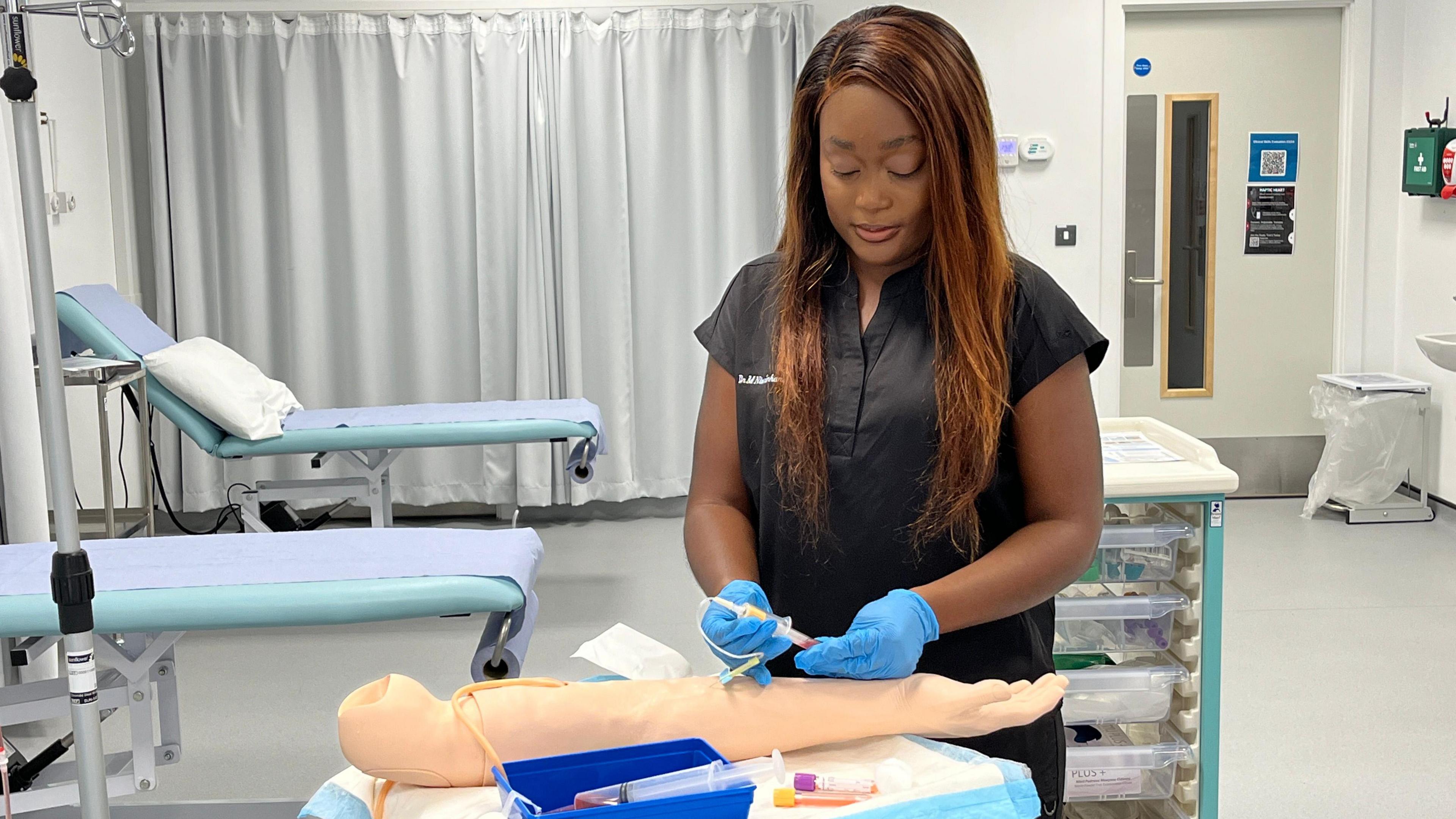 Dr Ntorinkansah during a training exercise on a dummy hand