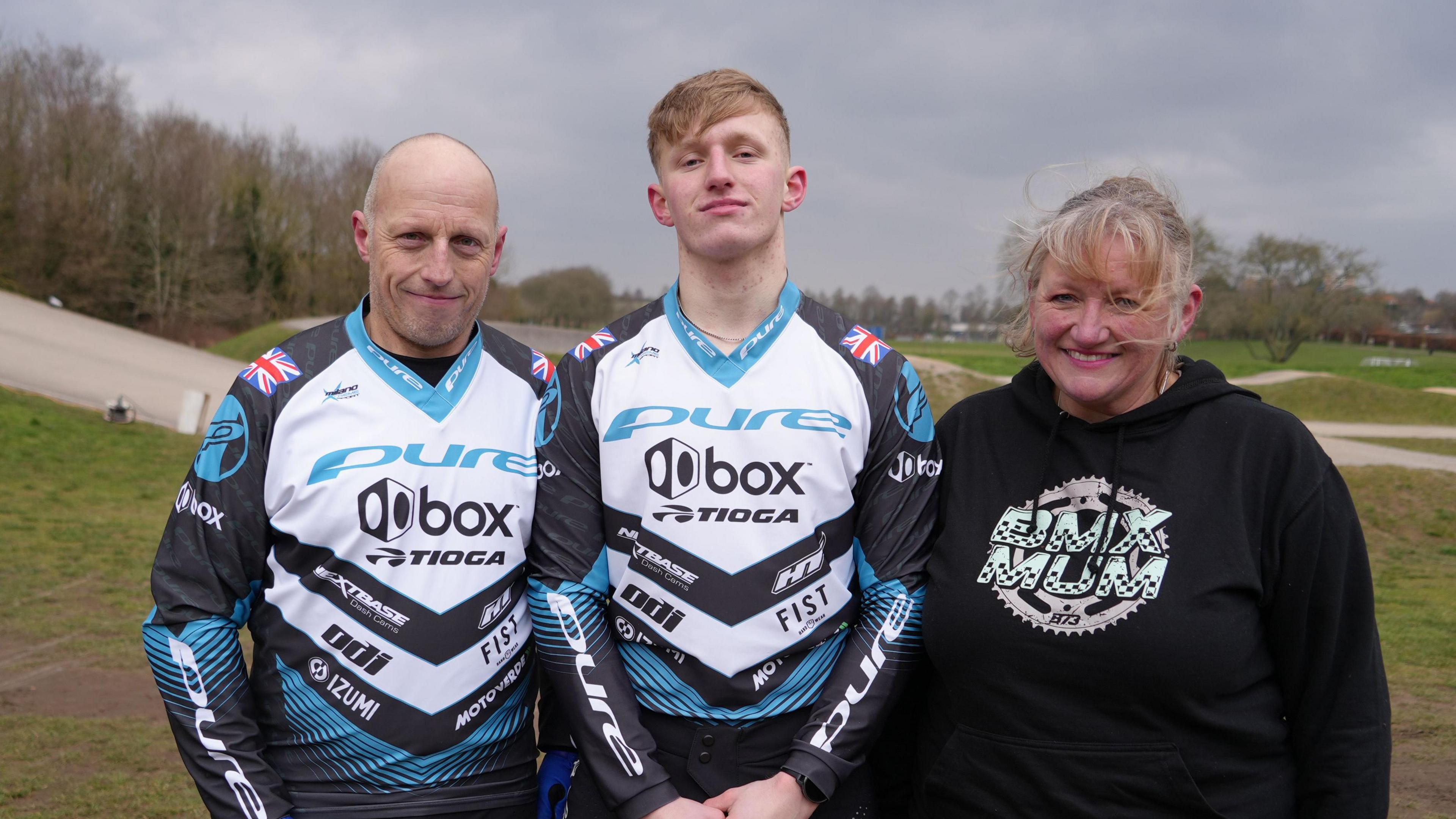 Family photo of dad Alan Hill on the left, Jared in the centre and mum Abi Hill on the right at the BMX track at Sloughbottom Park, home to Norwich Flyers.