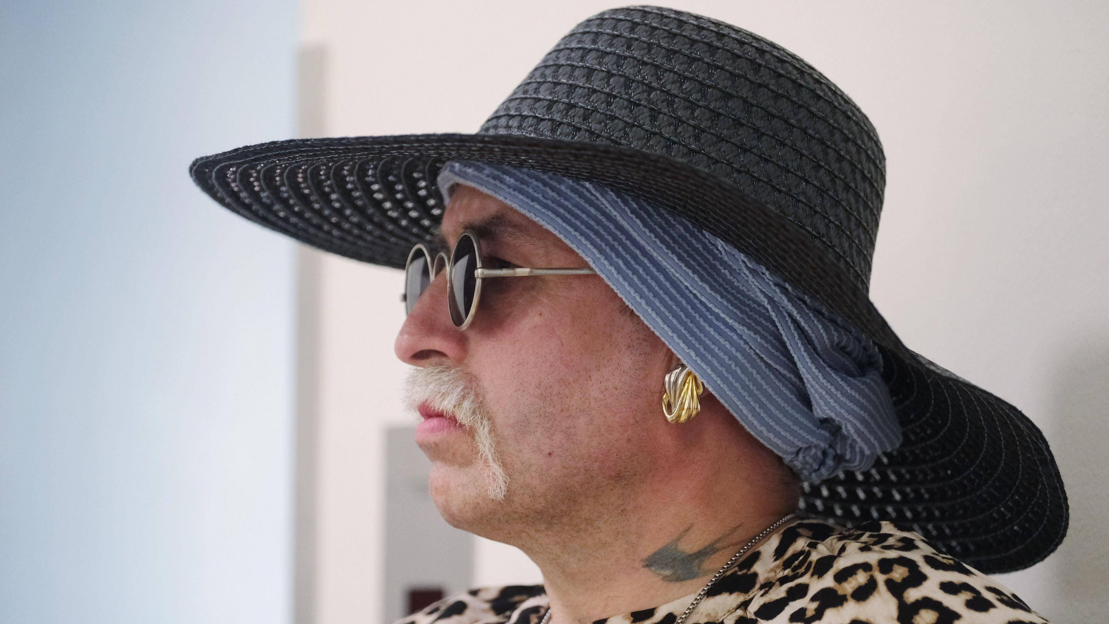 Marla-Svenja Liebich wears a blue hat and dark glasses - with a tattoo on her neck