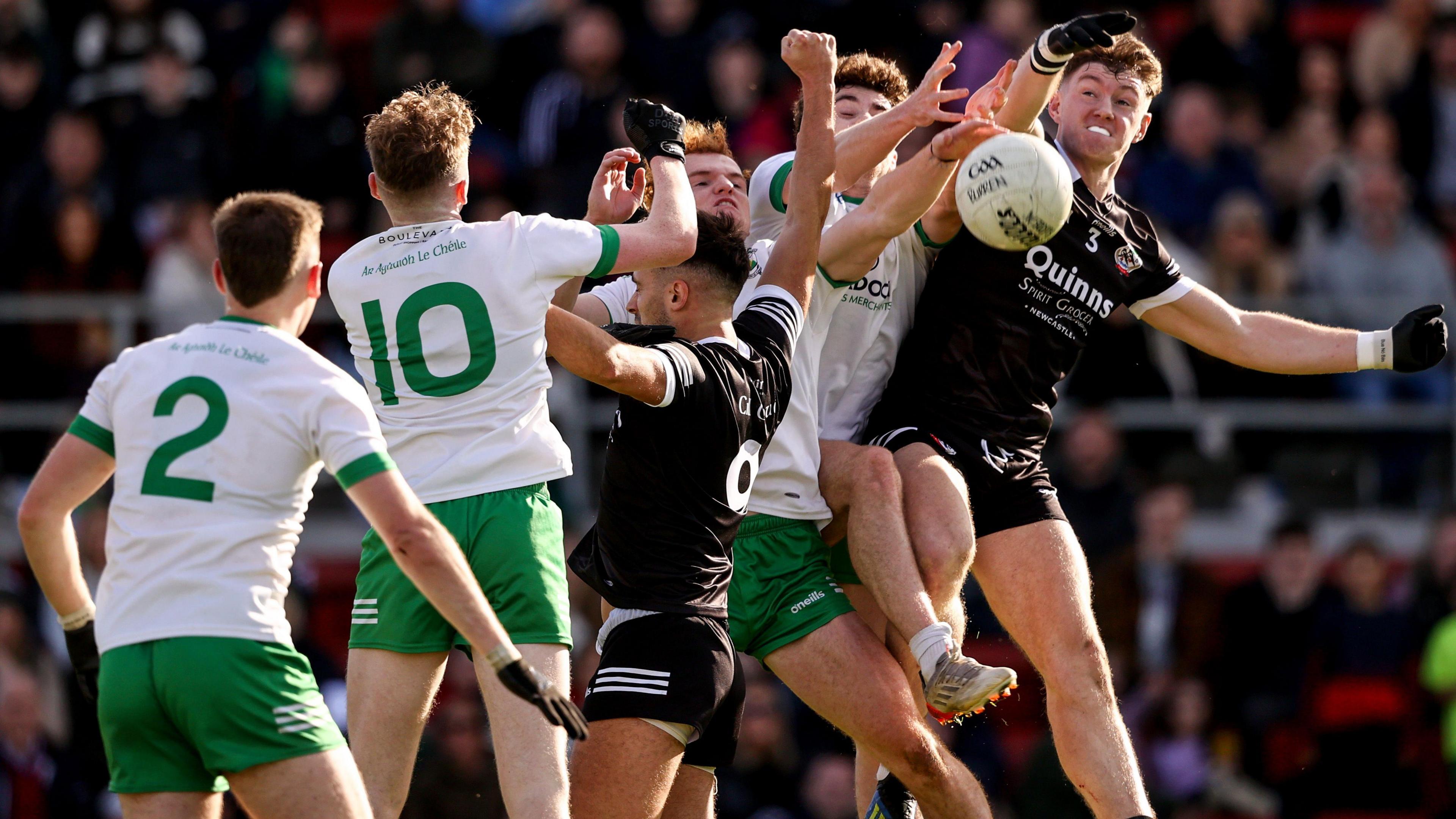 Burren's Danny Magill fights out an aerial battle with Kilcoo's Ryan McEvoy in last year's Down SFC Final