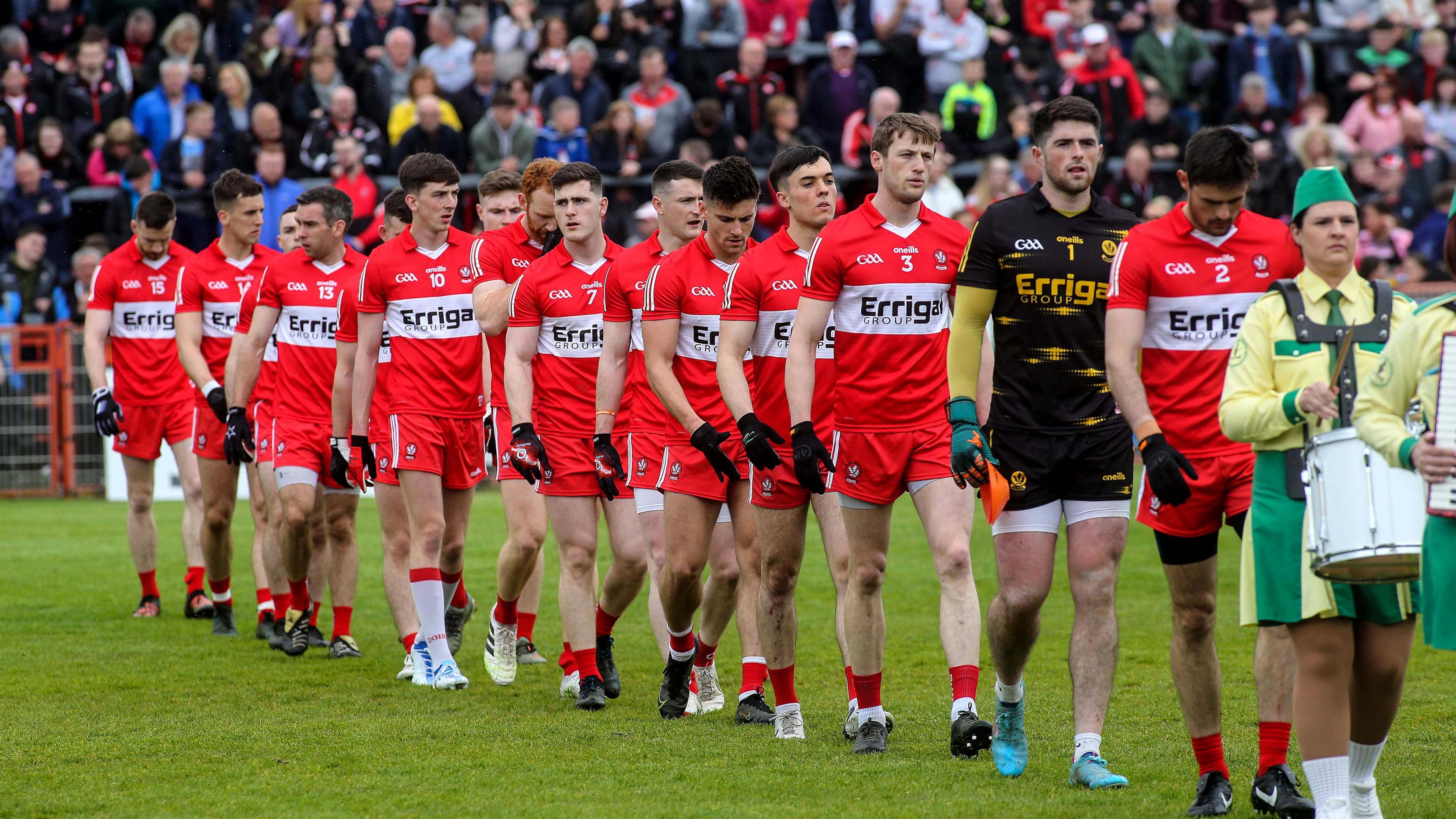 Chrissy McKaigue leads the Derry team out against Tyrone in 2022