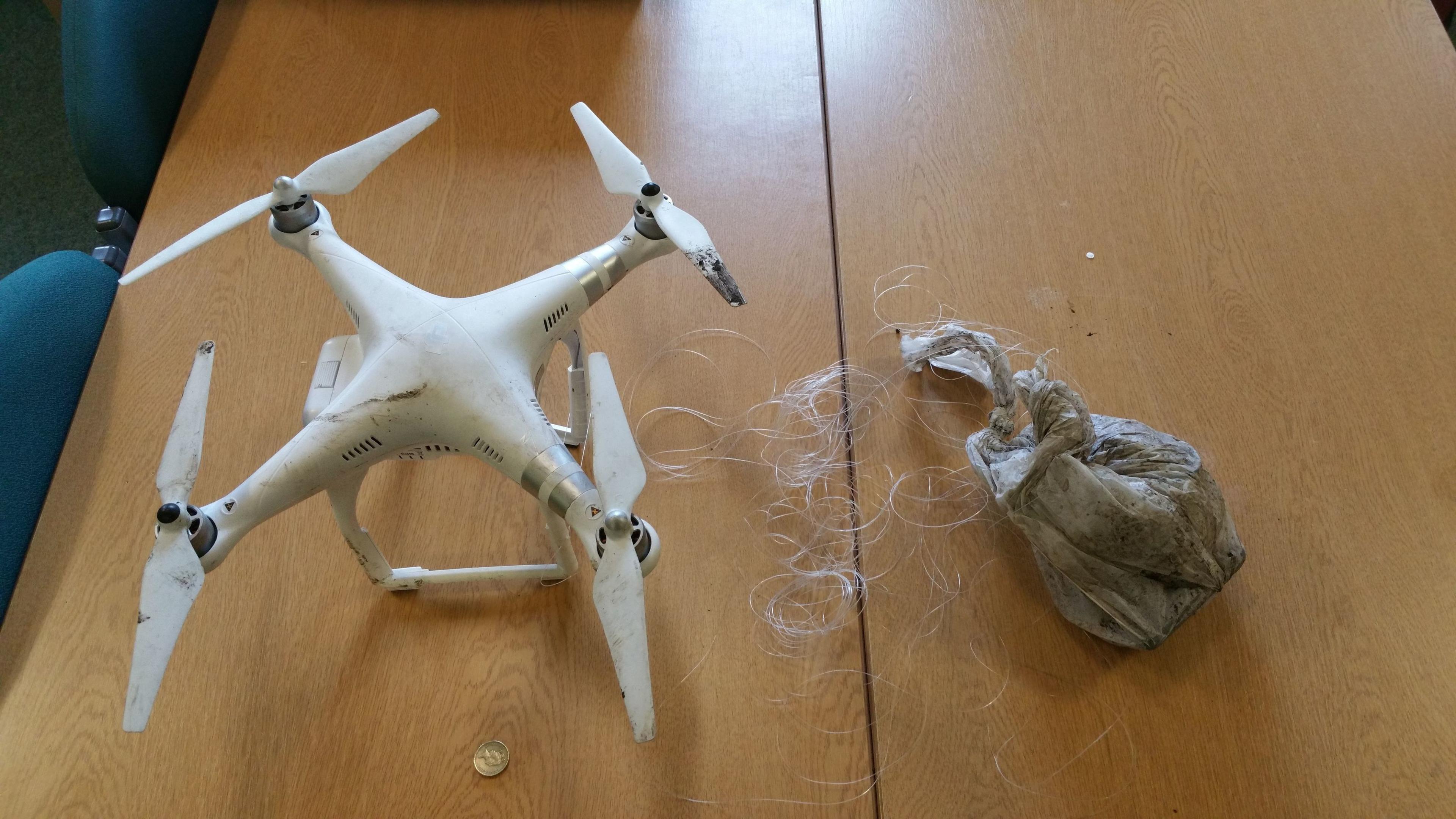 A handout photo issued by West Midlands Police of a drone and bag of drugs seized as a drug smuggling gang attempted to smuggle it into a prison in 2018.