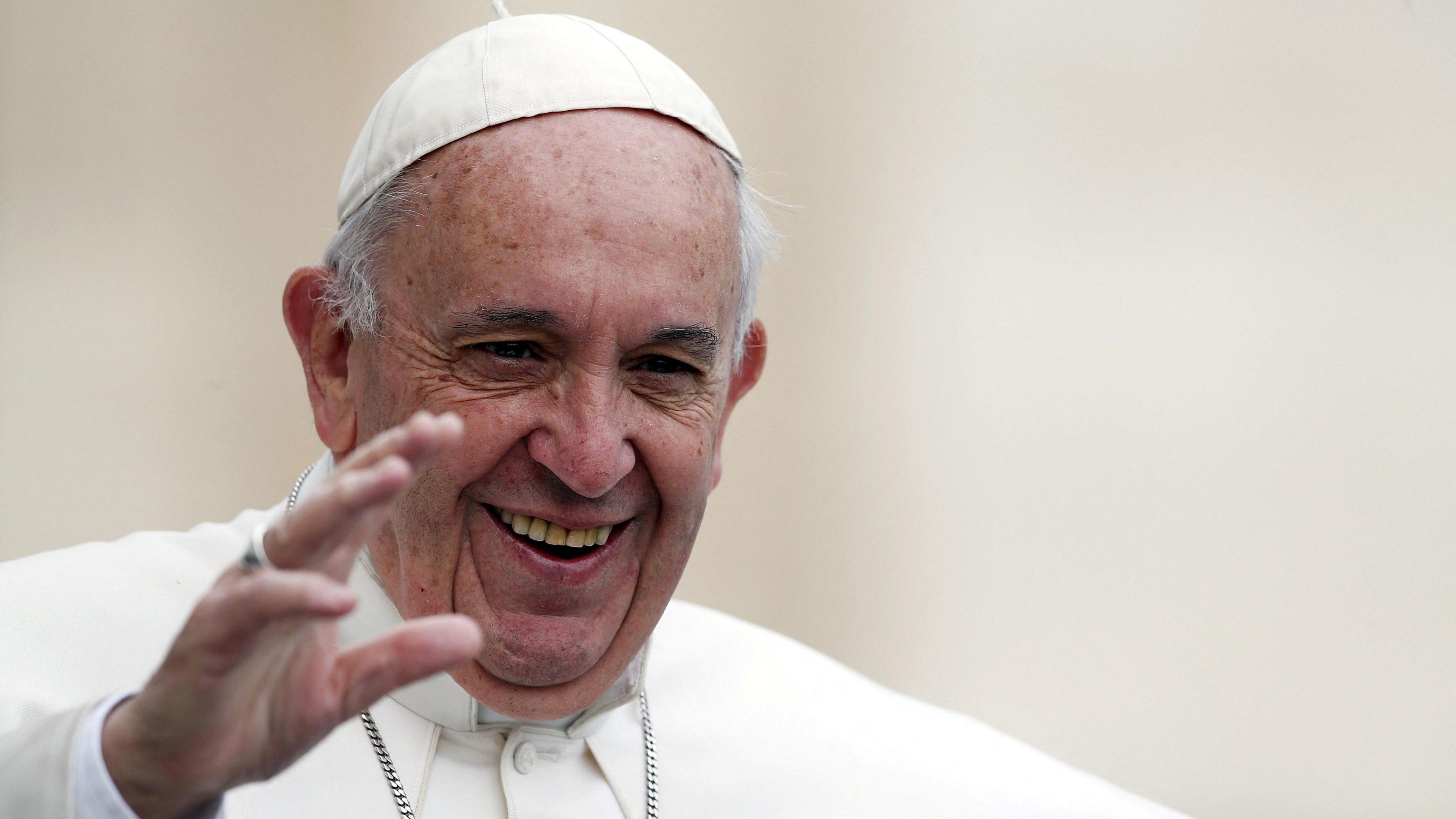 Pope Francis waves as he arrives to lead the weekly audience in Saint Peter's Square at the Vatican, October 21, 2015.