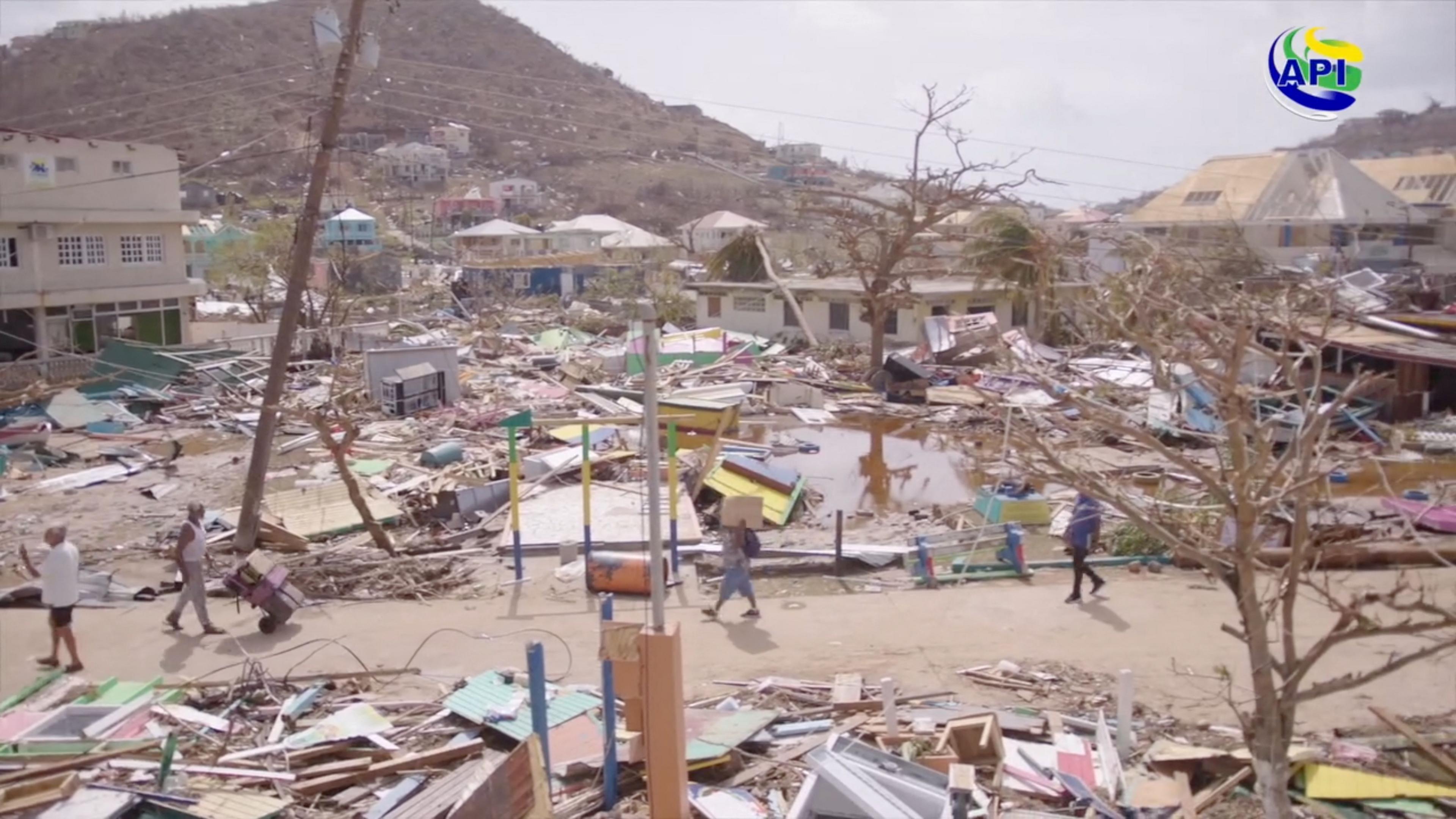 Dozens of smashed and collapsed houses litter the landscape