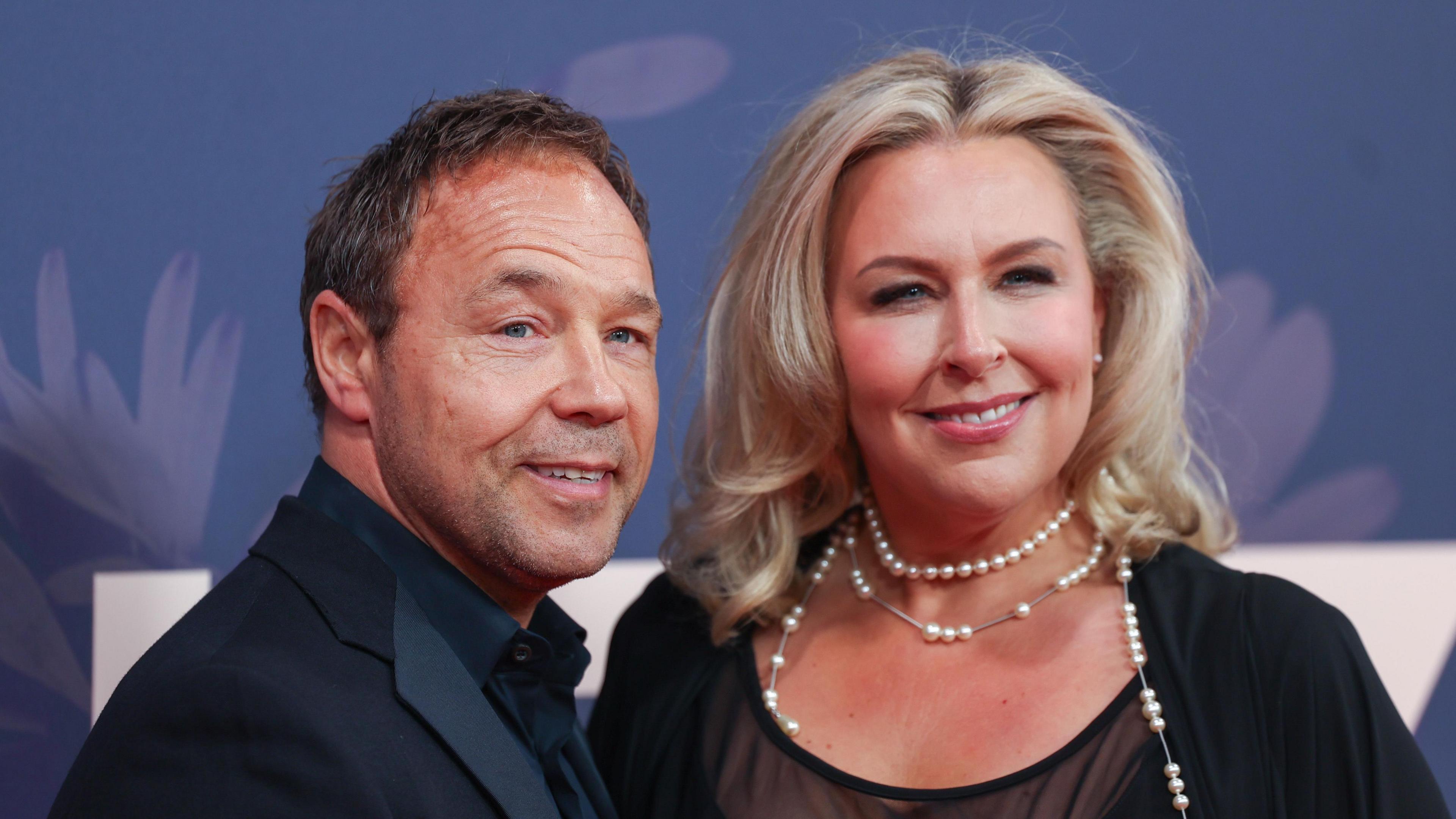 Photograph of Stephen Graham wearing a dark suit and Hannah Walters wearing a black dress. 