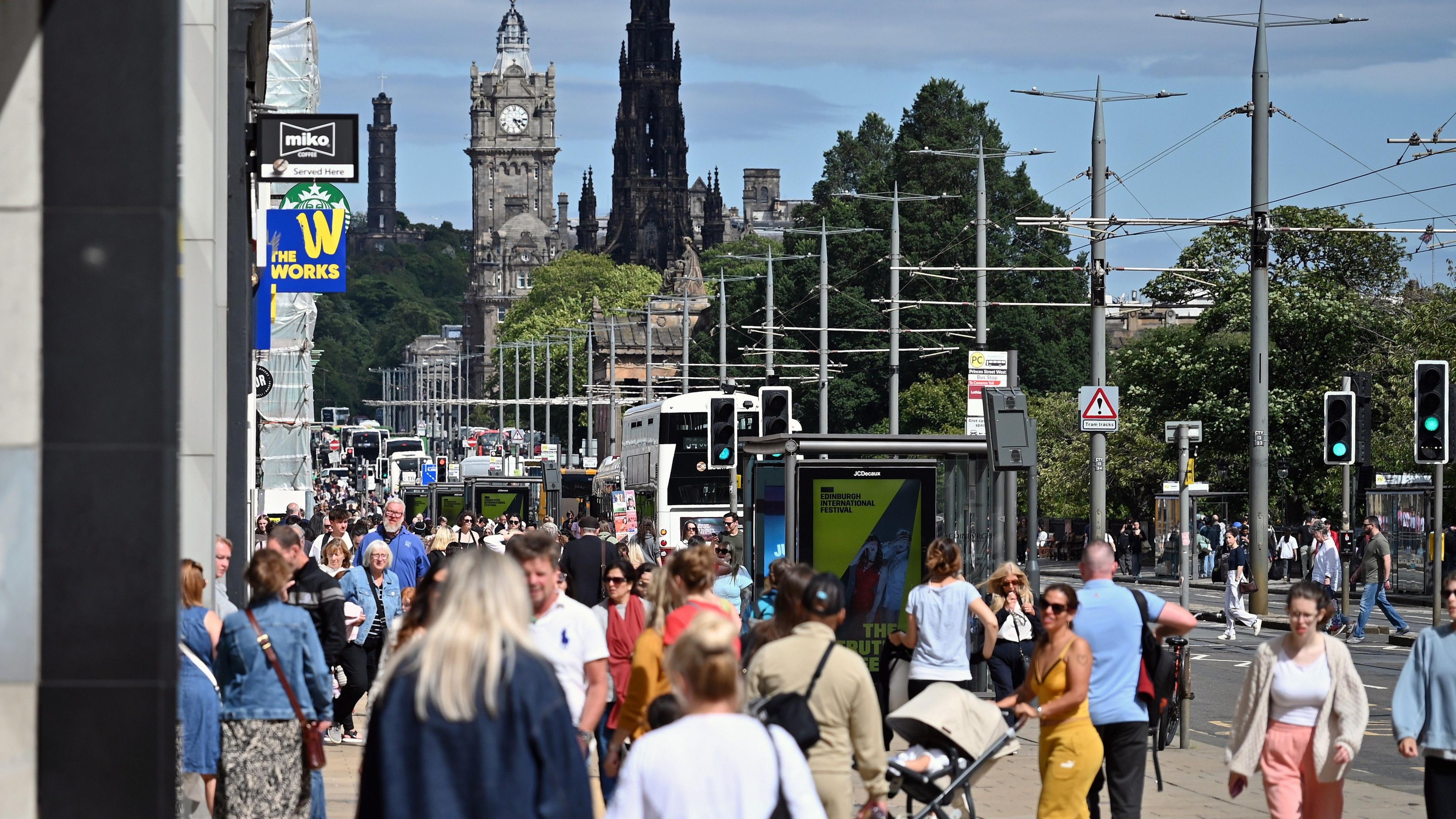 People walk on a crowded shopping street in Edinburgh