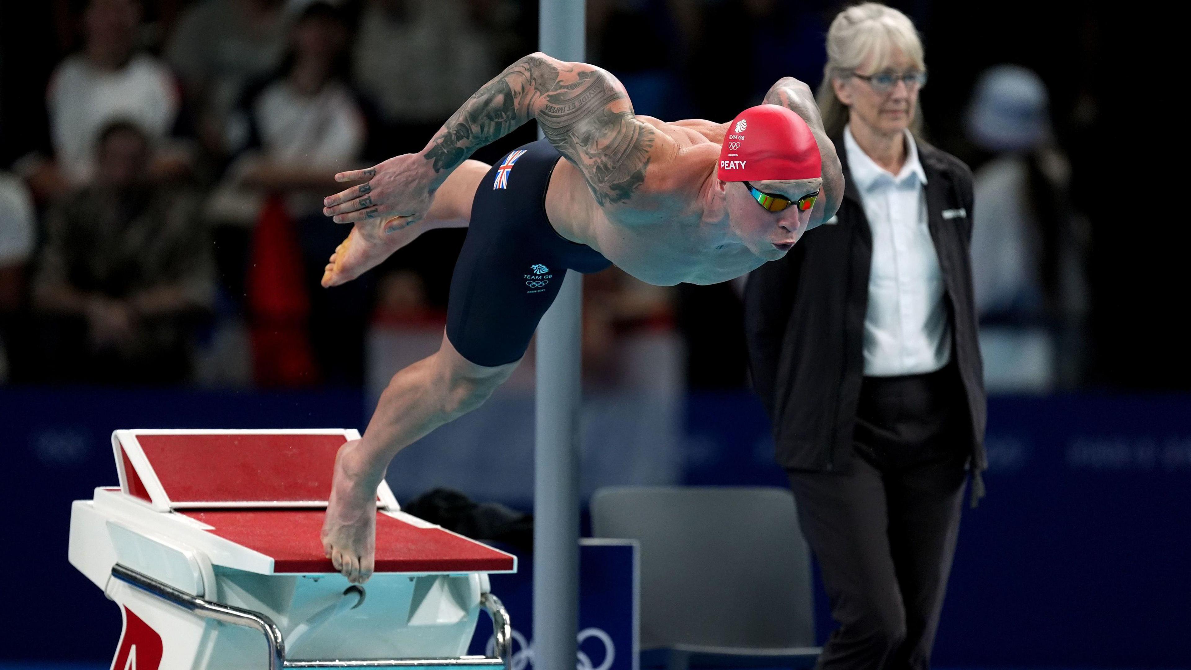 Adam Peaty launching into the water at the Olympic 100m breaststroke final 