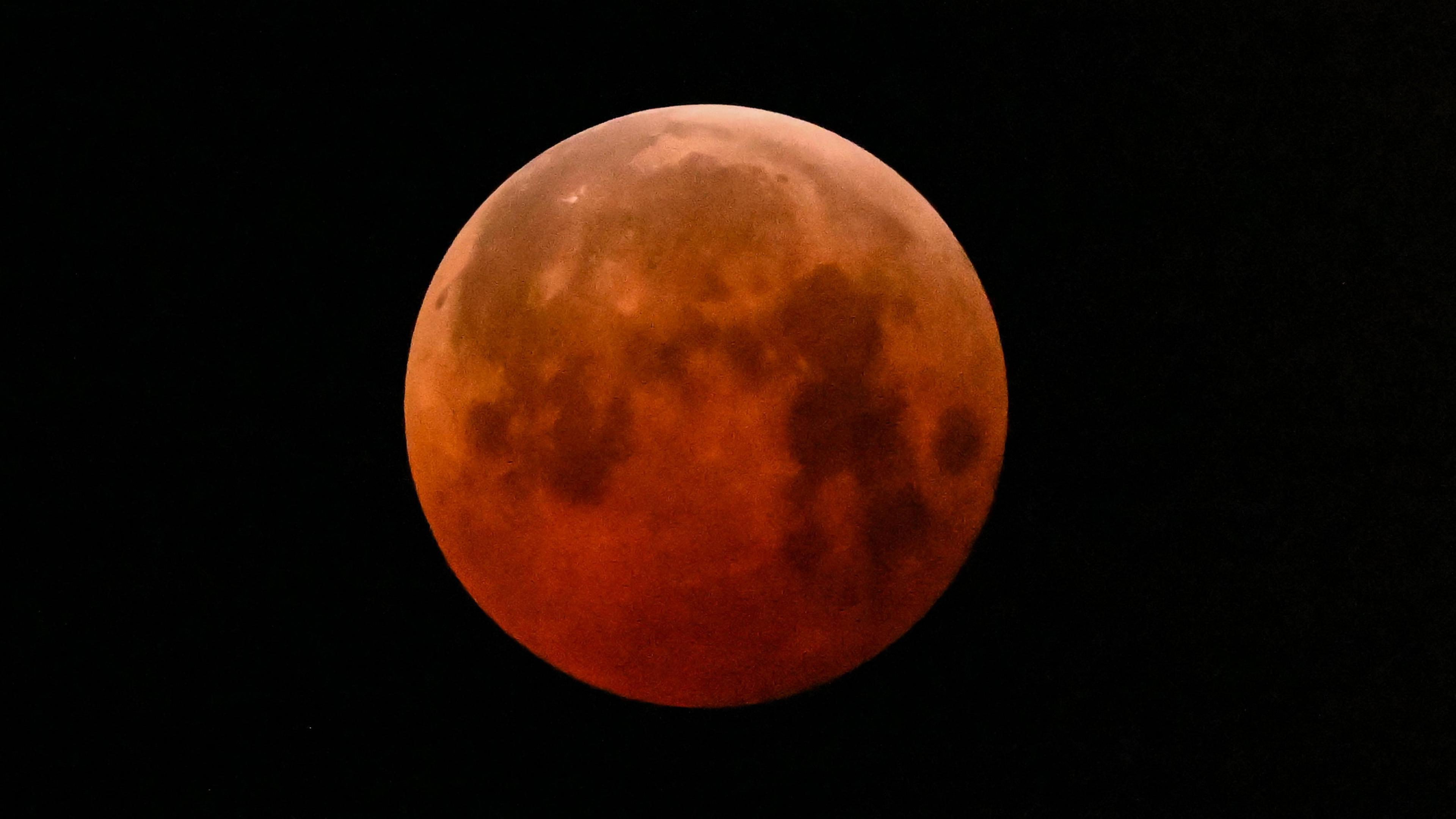 The full moon, also known as the "Blood Moon," is seen in Mexico City on March 14, 2025, during a lunar eclipse.