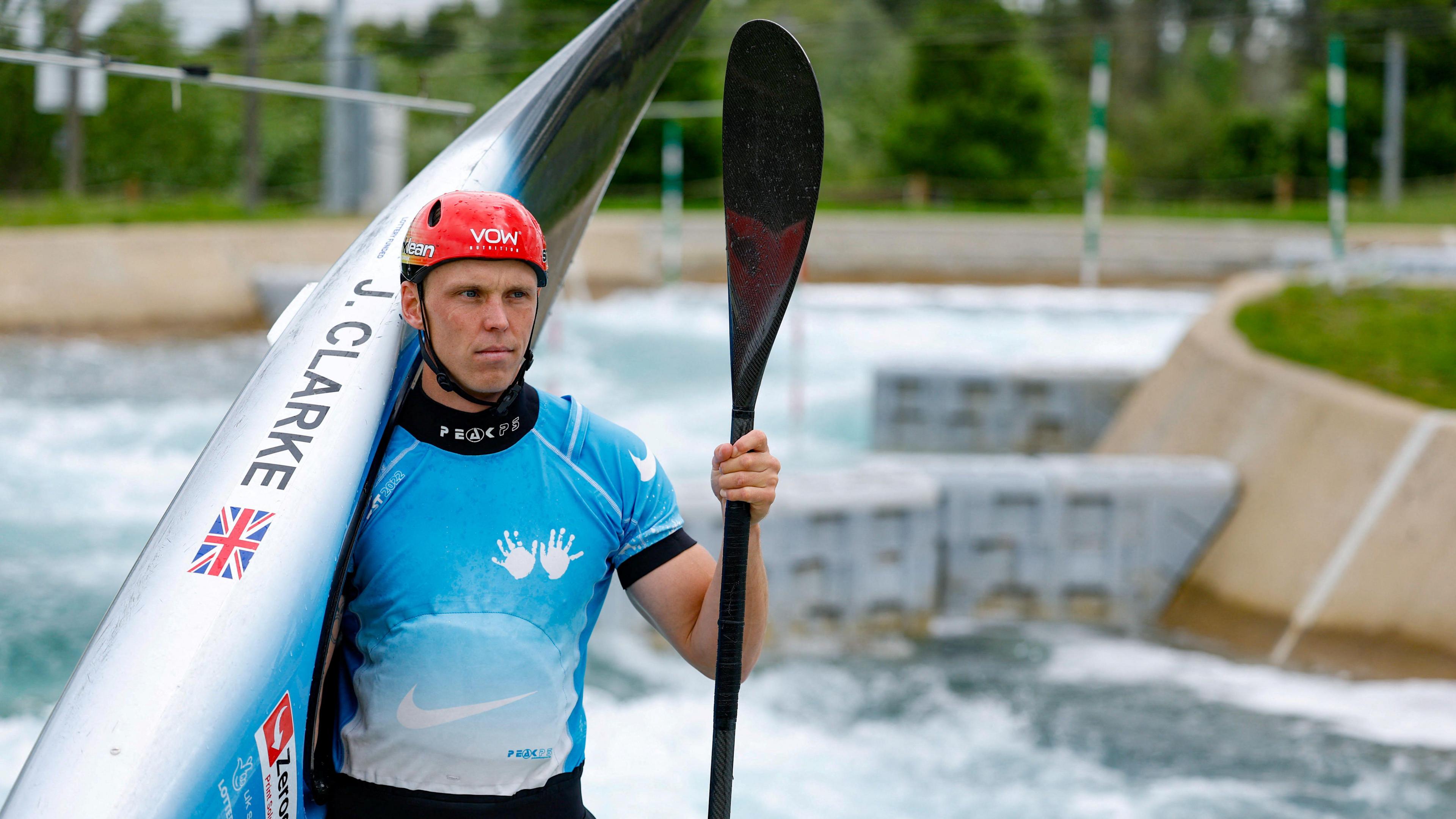 Joe Clarke holding is kayak and his paddle at the Lee Valley White Water Centre in Waltham Cross