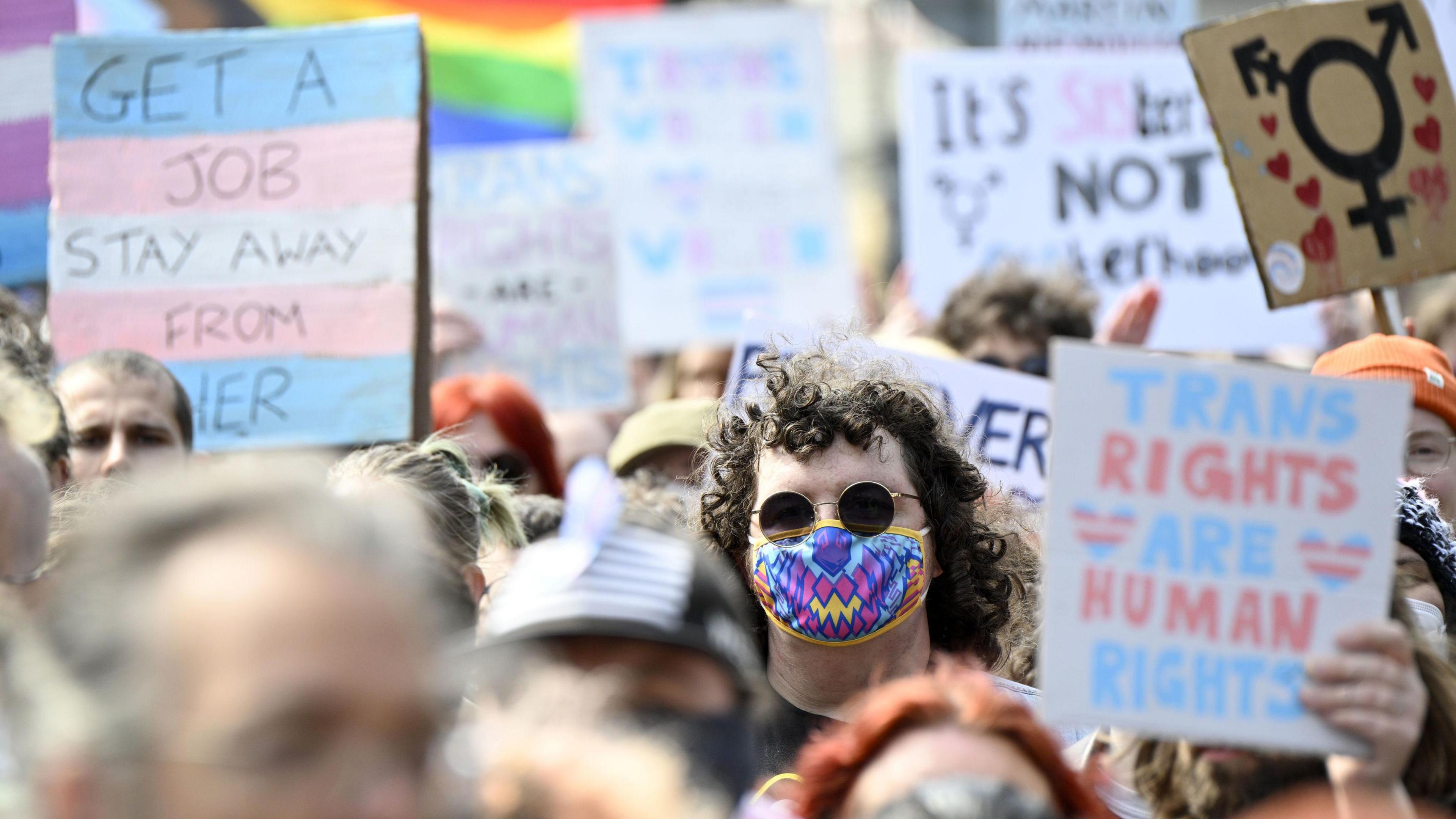 Trans rights supporters protest in Edinburgh, holding signs saying things like TRANS RIGHTS ARE HUMAN RIGHTS
