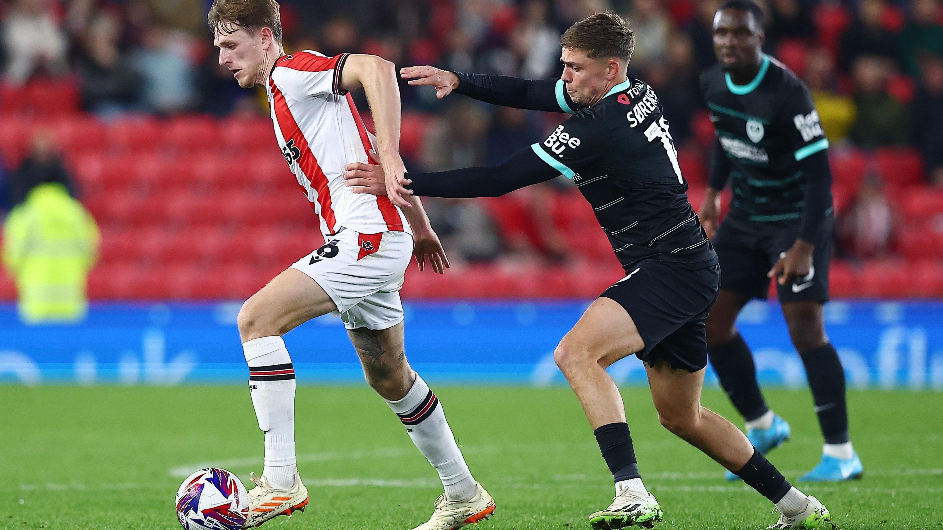 Portsmouth forward Elias Sørensen struggles to win the ball back off Wouter Burger of Stoke City in the 6-1 victory for the home side at the Bet365 stadium.