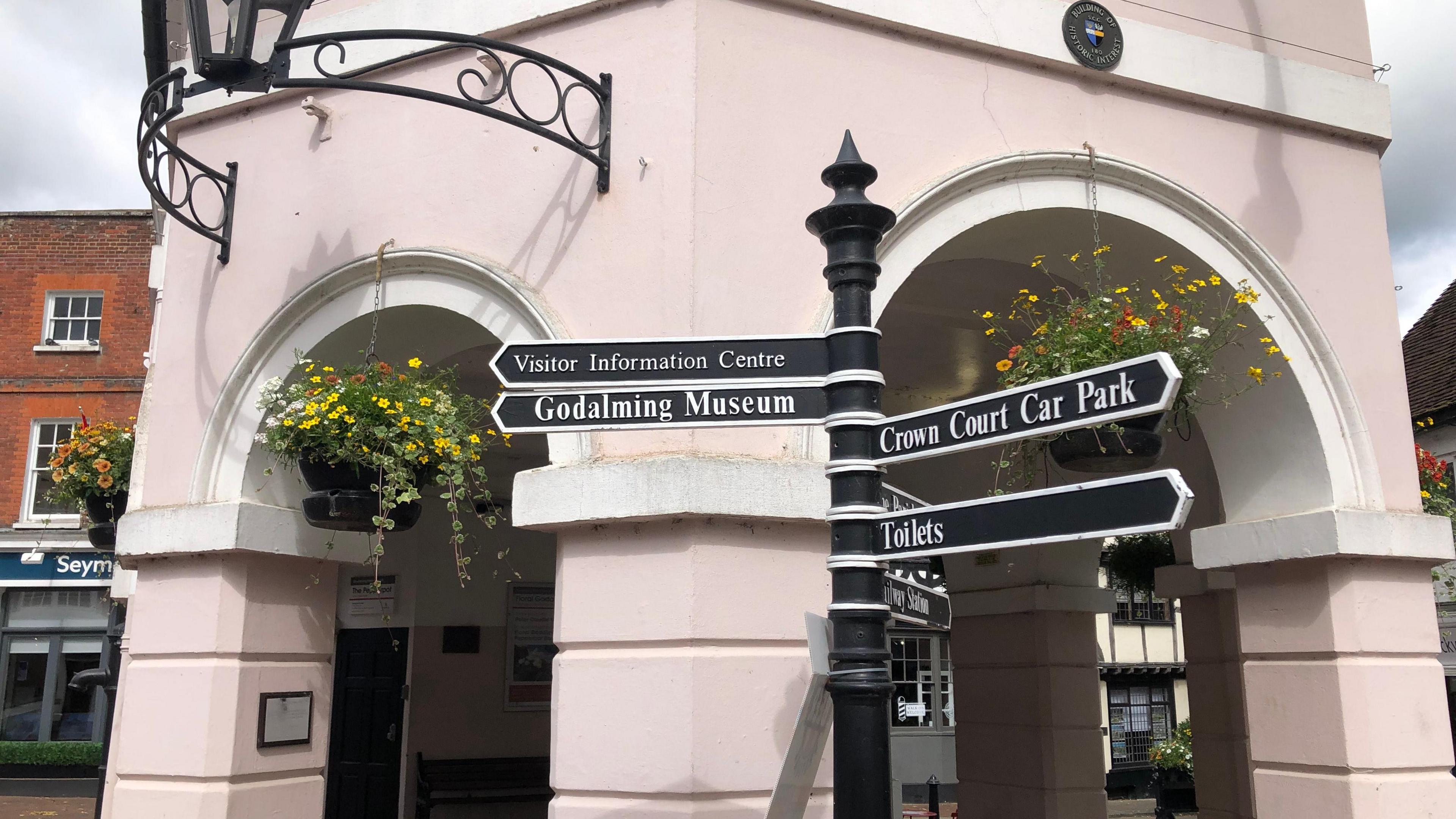 Close up of Pepperpot building, signs of directions for places to go