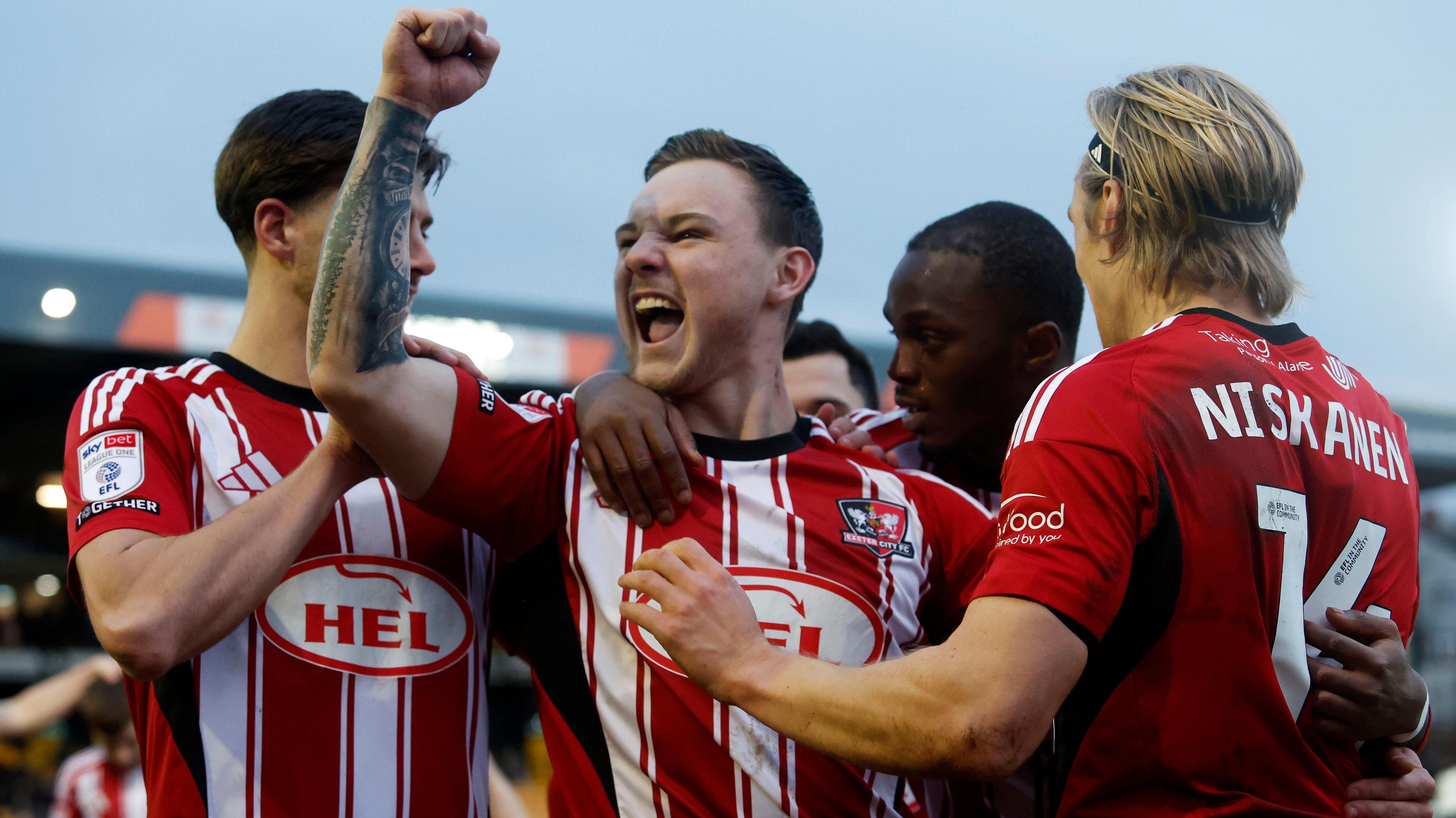 Exeter City players celebrate a goal