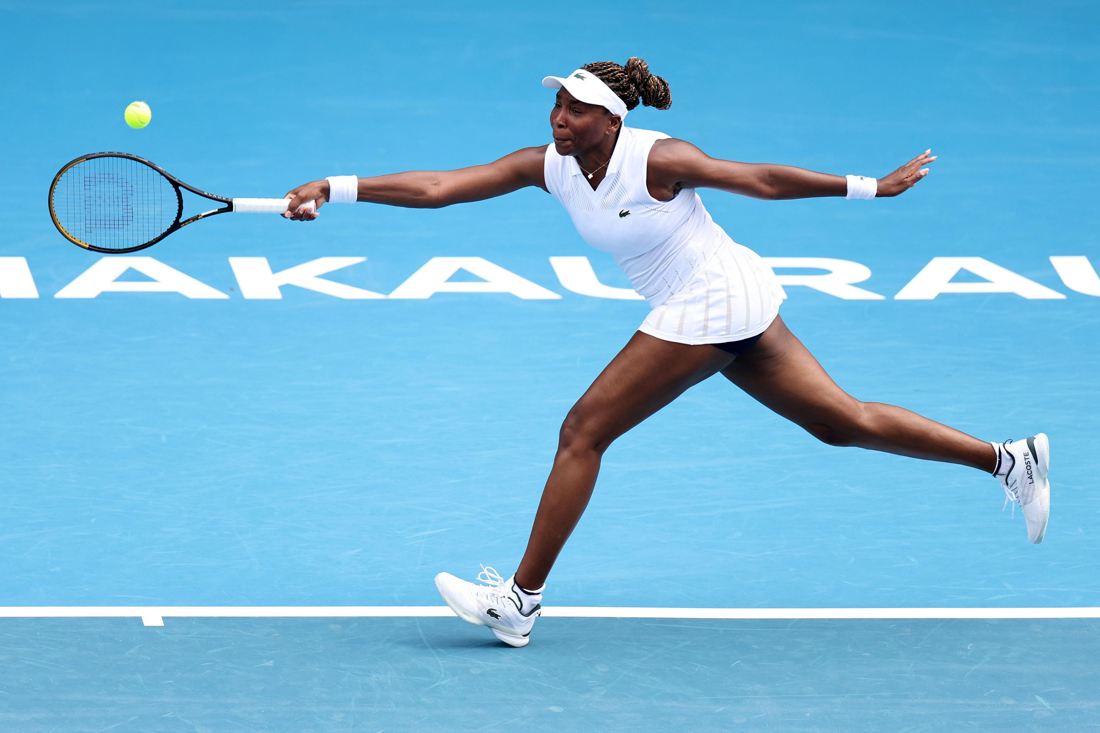 Venus Williams stretches forward and plays a shot in her match against Magda Linette during day two of the ASB Classic in Auckland, New Zealand. Photo by Fiona Goodall
